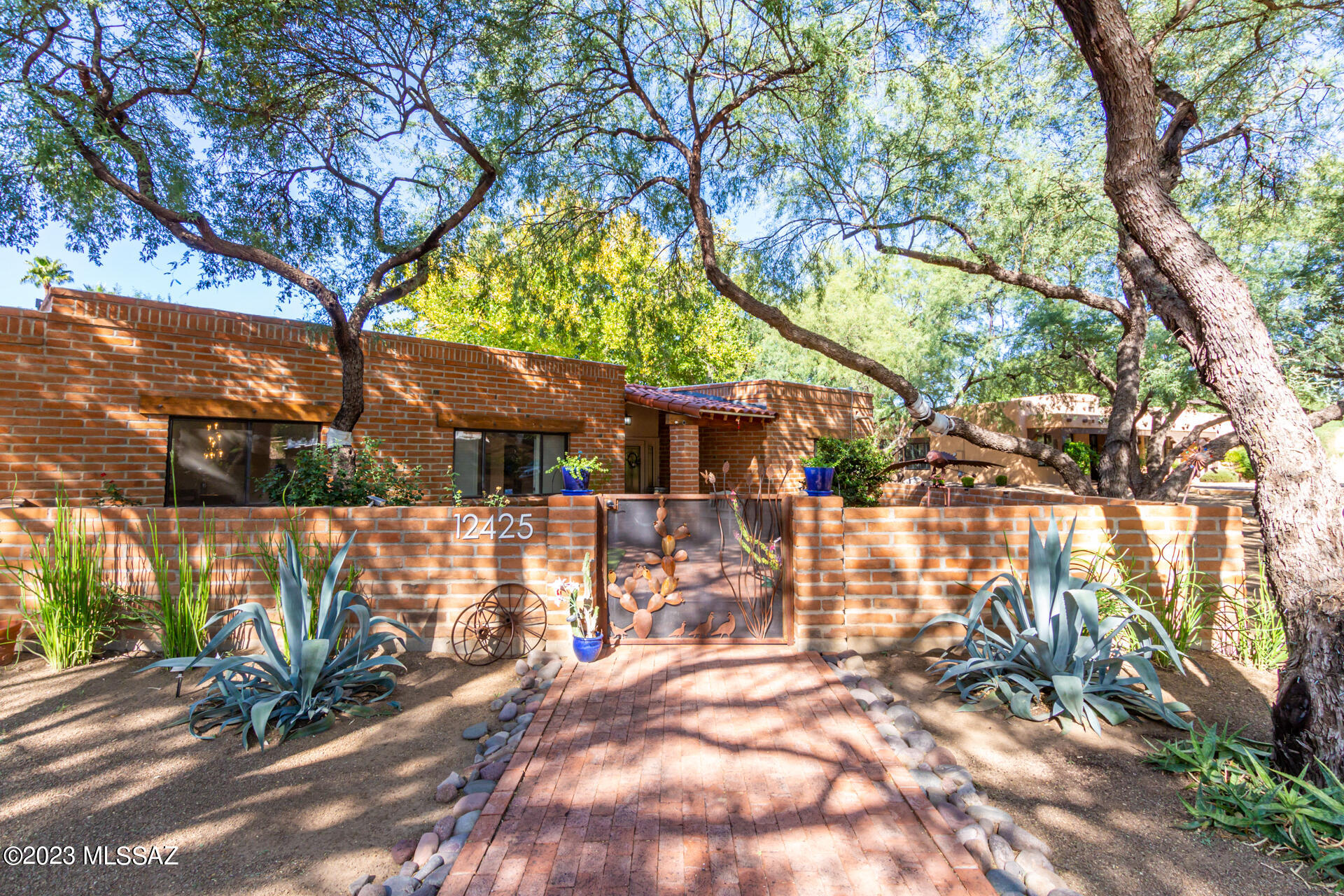 Welcome to the 49ers Country Club Estates, with Tucson charm, mature beautiful trees, golf course, clubhouse, pool, and unparalleled community events. This brick ranch style home sits on a private lot surrounded by 12 mesquite trees and a backyard meant for entertaining. 2633 plus square feet, 4 bedrooms, 2.5 bathrooms, with updates throughout. Brand new paver driveway and walkway to your private front courtyard with new turf. Grand entrance with custom glass double front doors, skylights throughout the home keep it bright and inviting. Your front living room and formal dining room lead into the remodeled kitchen with new appliances, granite counters and tile backsplash. Kitchen nook with windows to the resort style backyard. Guest half bath, laundry and pantry off the kitchen with entrance to the backyard patio. Family room has a cozy fireplace with views to the patio. 3 bedrooms and full bathroom lead to the master suite at the end of the hall. Master suite was recently remodeled to add sliding glass doors to the back yard, added master closet with custom features, modern soaking tub, dual vanity and a custom steam shower. Your resort style backyard is meant for friends and parties. New custom outdoor kitchen with every outdoor appliance, grills, under a covered ramada with lights, fan, granite counters. Pool with new turf, custom fire pit with built in seating, putting green, side yard patio ready for your garden. Concrete floors throughout, newer AC, new hot water heater, electrical box, rain gutters and barrels, new roof coating, security system, new solar, turf, gates, outdoor kitchen, see list in documents tab. This home has been updated with the utmost care and ready for its new owners to utilize this amazing place in the incredible location of 49ers Country Club. The club is affordable to join and offers a gym, pool, golf, driving range, restaurant, and coming soon bar area. Both the Country Club and Social committee host many events throughout the year at most Holidays. This community prides itself on the families that help make it so special. Join the 49ers Club today!