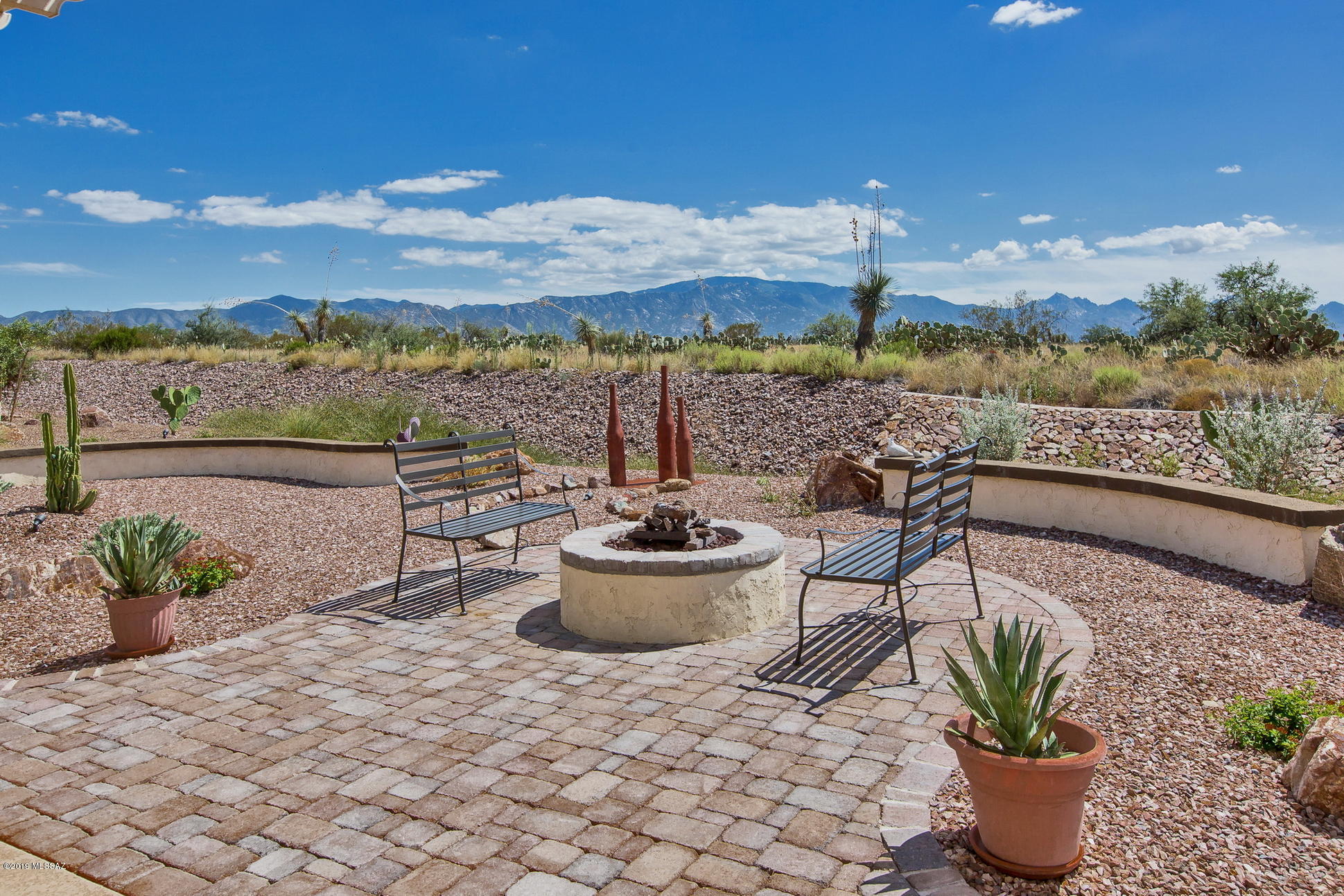 This popular Dolce model features unobstructed Catalina Mountain Views and open desert!! The home is made to enjoy the outdoors of the Sonoran Desert.  Extended paver patio with pergola and sunshades provide for year round outdoor entertaining and living. Enjoy your evenings under the stars year round by the built in fire pit.   Mountain and desert views from the Great Room ,Dining Room and Master Bedroom.  Bay windows and extended Master Bath/Closet/Linen. Enjoy the wonderful Saddlebrooke Ranch amenities including indoor pool, beach entrance pool which includes a cross current walking section, outdoor spa, creative arts center, golf course & driving range.