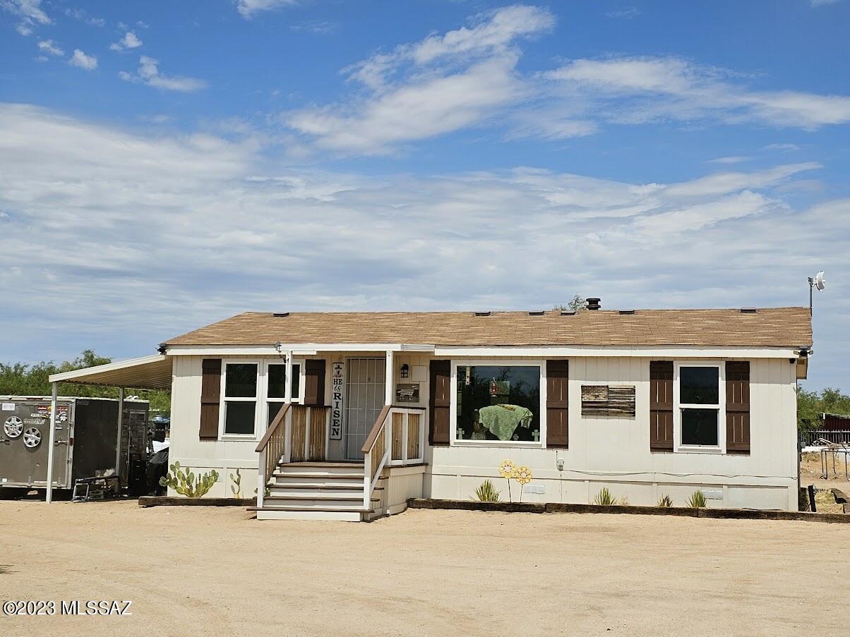 Upgraded in 2020, this charming home offers a remodeled kitchen, new cabinets, stainless steel appliances, and renovated bathrooms. Stunning view of Quinlan Mountains and Kitt Peak Observatory through upgraded windows. The AC system was replaced in 2020. The solar is financed, not leased.  Panels are brilliantly installed on a separate structure, not connected to the roof so there's no risk of damage. Fenced 1-acre lot includes a horse corral, coops and pens. Experience tranquility and modern comforts in this delightful home. Owner just re-shingled roof.  Solar will be paid off with full-price offer or buyer to assume financing.