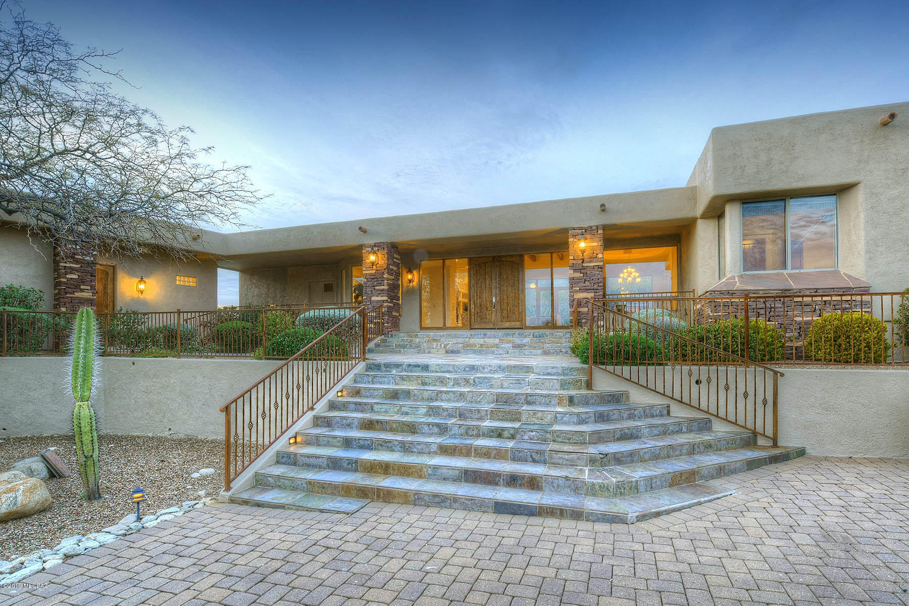 Beautiful contemporary home at the end of a cul-de-sac with mountain and city light views & a generous guest house. Enter into the large great room for living and dining with wet bar and floor to ceiling picture windows. Spacious family room with gas fireplace opens to wrap around kitchen with double ovens and granite counters. Luxurious master suite with his and her walk-in closets. Guest house has full bath and kitchenette. North facing backyard with pool, spa, waterfall, outdoor shower and BBQ area to entertain.