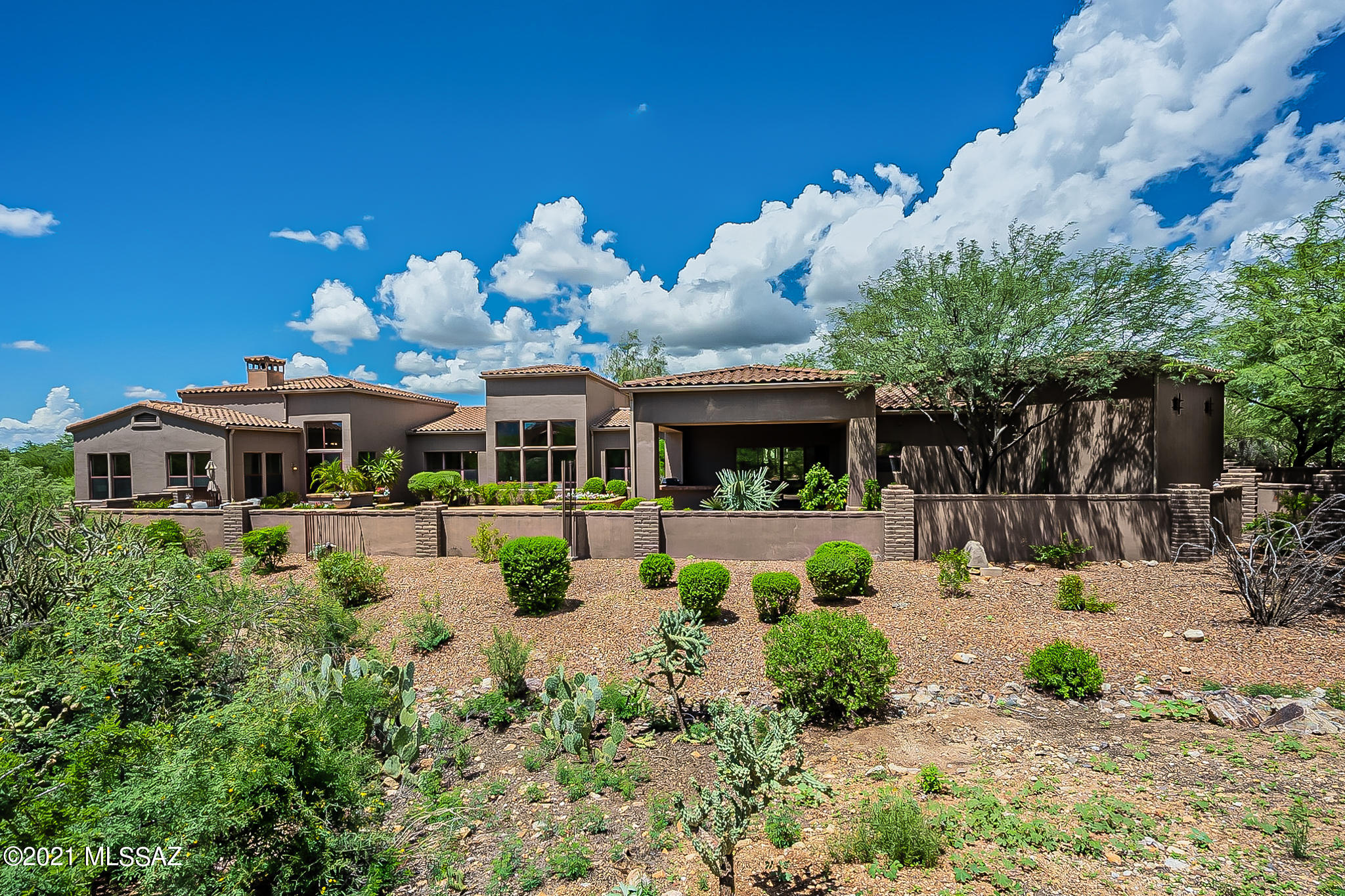 Custom, contemporary Tuscan style home located in desirable gated Honey Bee Canyon Estates: A lovely front courtyard greets you as you enter this stunning, custom showcase. Statement windows frame stunning mountain views from front entry through formal living area, picture windows capturing the ambiance from room to room.
Coffered ceilings, travertine and wood flooring complete the look. Chef's kitchen w/abundant work space feature Viking appliances, new backsplash and quartz counters with waterfall edge providing ample seating. In addition, 2 guest rooms have ensuite bathrooms. Dramatic Santa Catalina views overlook a resort-like salt water pool & barbecue area perfectly designed to extend your living space. Complete remodel summer of 2021: Amazing feature list attached in documents tab.