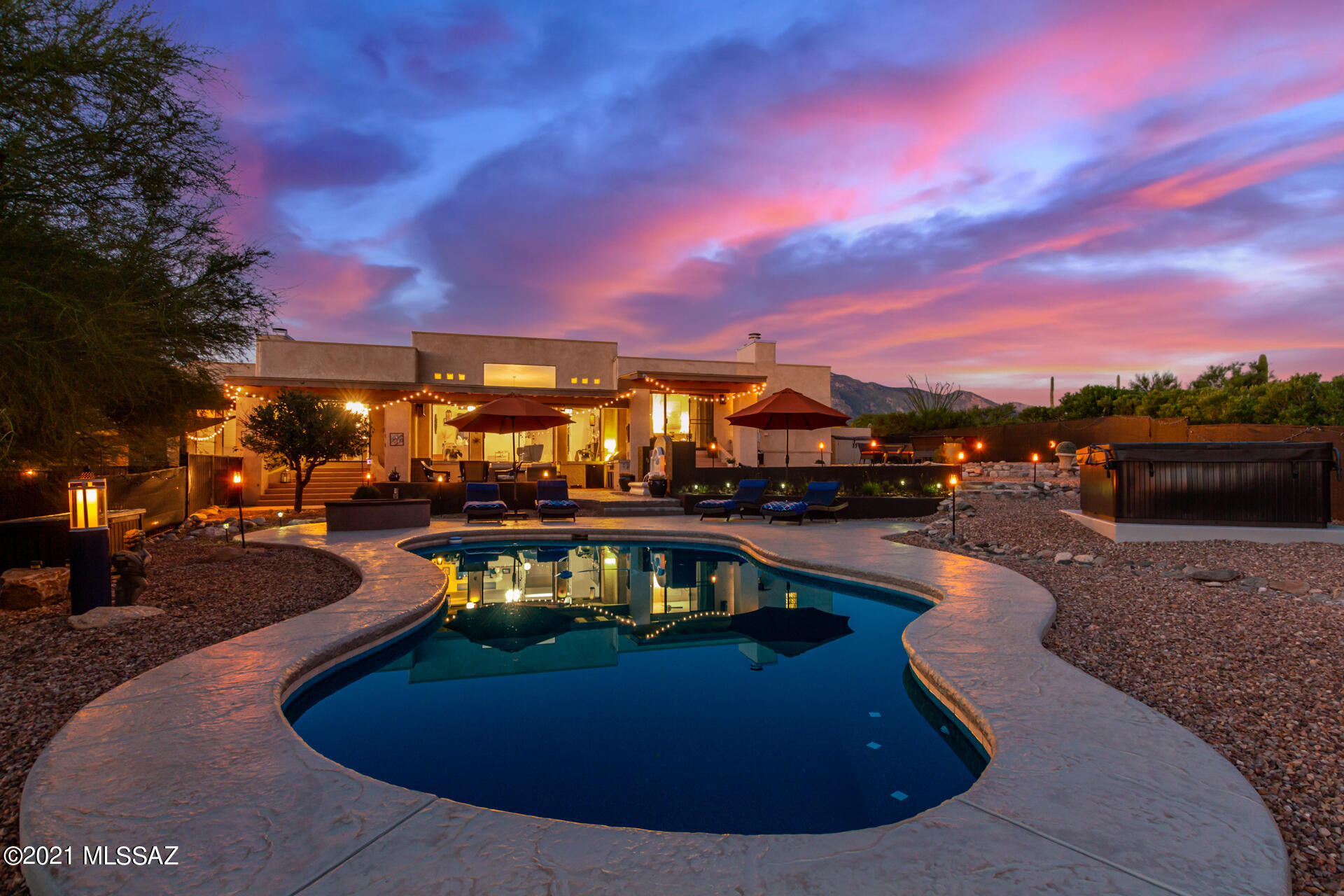 Gorgeous home located end of cul-de-sac, with stunning views of Catalina Mountains, and a private backyard oasis, located in the much sought after Shadow Hills. This home has floor to ceiling windows, wood flooring throughout, with modern light fixtures, & abundant natural light. Great room makes entertaining a bliss with access to the backyard and outdoor fireplace. Stunning kitchen offers large wood cabinets, updated appliances, mosaic backsplash, and oversized island with wine fridge. Master bedroom has backyard access, fireplace, a walk-in closet, & spa-like en-suite with jetted tub. Outstanding resort-like backyard has a sparkling pool, relaxing hot tub, multiple seating areas, fire pit, and built-in BBQ. Luxury and Privacy! You do not want to miss this one of a kind home *Multi-room Surround sound connected to outdoor area. 
*Outdoor fountain by the patio
*Electric sun shade(solar generated) on W side of the patio.
*Interior of the home was completely repainted
*NEW HOT TUB (2020-21)
*NEW DRIVEWAY (2020-21)
*Main bath updated (2020-21)
*Modern light fixtures (2020-21)
*Laundry updated including Granite counter tops (2020-21)
*NEW GARAGE DOOR (2020-21)
* Pool area, Upper area, and front entrance (granite-look) concrete overlay (2020-21)


Bathrooms, and laundry room travertine tile. Main Entrance is limestone.