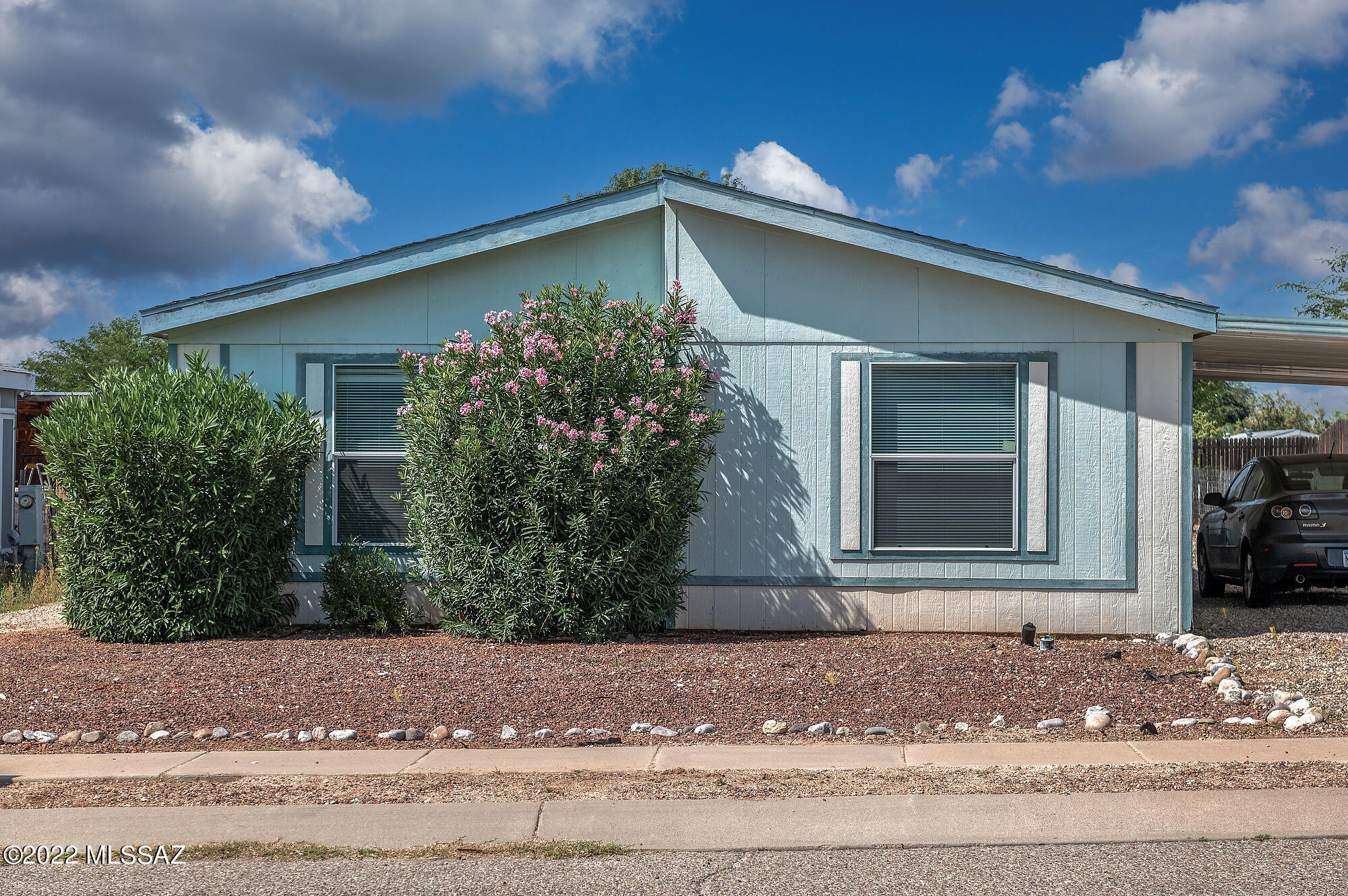 Priced to sell! Ground set manufactured home with three bedrooms and two bathrooms and an open floor plan. Convenient location near the Loop, riding trails and washes and popular horse stables. Home features a large great room with dining and a separate dining area off kitchen. Kitchen includes all appliances with a bar and island. Outside is a covered patio, storage shed and large yard waiting for your personal touches.