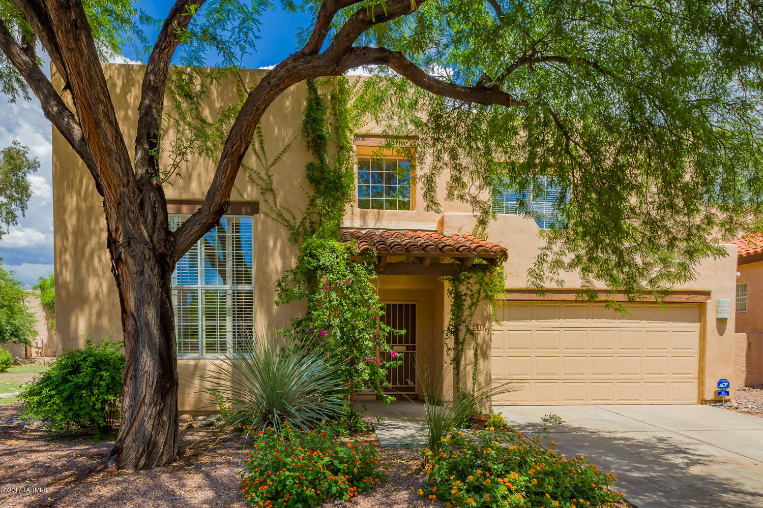 Clean & Move in Ready with Storage Galore in Desirable Mesquite Creek! Soaring ceilings, 20'' tile floors, 1st floor bedroom & full bath + 3 bedrooms & 2 baths upstairs all with tile floors & walk-in closets. Built in office space in bedroom 4. Abundant cabinet space in the kitchen with center island + breakfast area. Kitchen open to family room with cozy corner fireplace & built-in entertainment center. Laundry room with built-in cabinets & front loading washer & dryer. Lush backyard with grass & mature trees & a peak of the Catalina Mtns from the north facing backyard & a better view from the 2nd floor private balcony off the Mst bedroom! Home is located right around the corner from the River walk for dog walking, jogging or strolling! The community pool is also within walking distance. Central Vacuum System, Plantation Shutters in the Great Room and white wood blinds everywhere else. Dual HVAC with newer unit on second floor. Seller including one year American Home Shield Home Warranty.  HOA fee includes community pool and front landscaping. This home is a must see and is priced to sell!