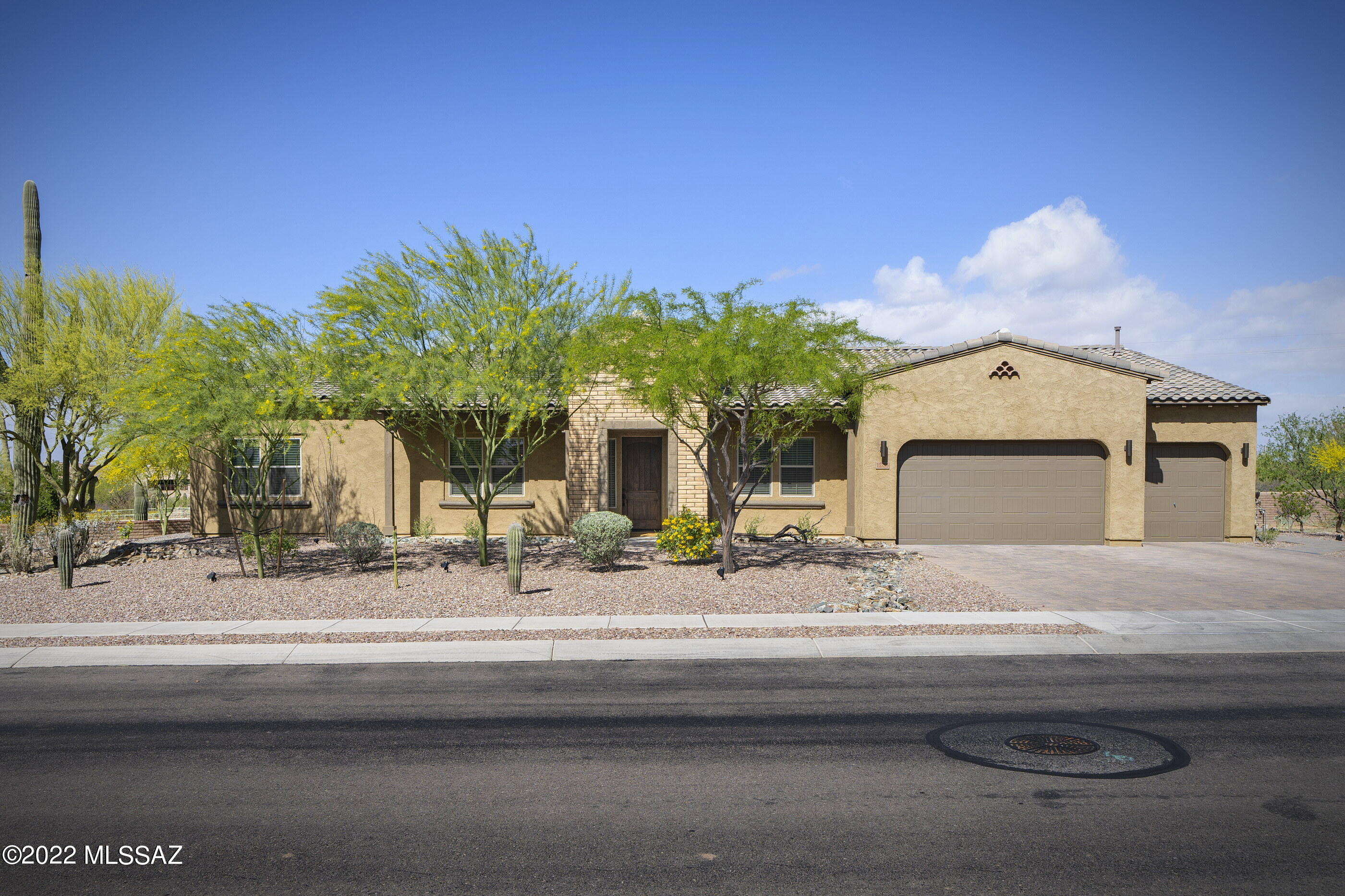 Don't miss this stunning, meticulously maintained home in gated Rancho Del Cobre. This 2017 Maracay home offers spacious indoor & outdoor living & stunning mountain views. Front entryway opens to a large living area w tons of natural light.  Gourmet kitchen, w its beautiful Maple cabinets, granite countertops & SS appliances is the perfect space for gatherings. The large master suite, complete w soaking bath, walk-in shower & oversized closet. Separate guest wing has 2 bedrooms each w their own bathroom. Updated lighting throughout & automatic shades in living areas. Beautifully landscaped backyard w remote controlled shades, heated pool w water feature & endless mountain views. Patio gas stub. Water softener. Extended 3-car garage w plenty of storage & work space. Work bench conveys Refrigerator, washer & dryer do not convey.