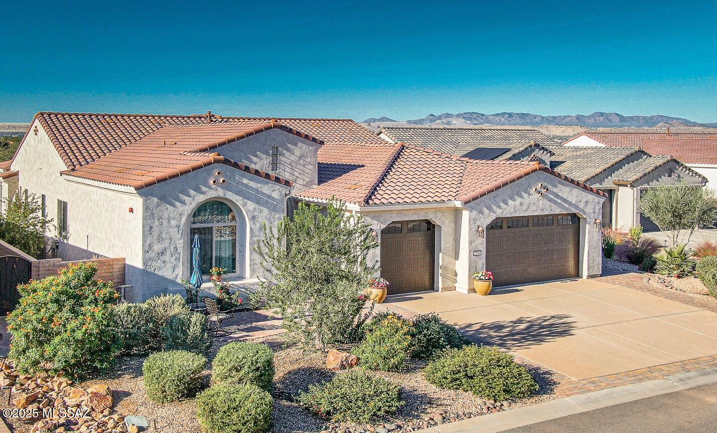 3-year old Avalon floor plan on a prime lot in Quail Creek with mountain views ,
privacy, no rear neighbors and upgrades throughout!  Located at the end of quiet street with a cul -de- sac.   2968 sq ft + Extended Patio Oasis. 2-BR Suites   2- 1/2 Baths + Den + Sitting Room (or Hobby/craft room or optional 3rd BR) This light filled home is an entertainer's delight, both inside & out with maximum extensions to rear covered patio, and center opening sliding glass doors in great room, to step out to the privacy and views in the rear yard with; fire pit, outdoor gas fireplace on covered paverstone patio, bult in grill, mounted TV, grass, solar screens, and plenty of room to add a pool too! Kitchen & Great Room with distinctive coffered ceilings. Kitchen cabinets upgraded 41''Alder soft close with roll out shelves. Quartz countertops, under & over cabinet lighting, large island with Blanco granite undermount sink. GE Monogram appliances including 5 burner gas cooktop and smart wall oven. Large walk-in pantry. Additional upgraded cabinets with quartz countertops in Butler Pantry/Coffee bar, Dining area and Great Room with built-in beverage cooler. While enjoying the Dining room, you'll have a view of the mountains and rear yard. Additional sliding door to patio oasis from dining area too. Attractive 18" ceramic tile in all main areas with carpet in Guest Suite, Sitting room and Den. Spacious Primary Suite with custom bookshelves & extended closet for maximum storage. Primary bath with both shower and walk - in luxury jetted spa tub, dual sinks with vanity. Guest suite is the ideal size and layout for your visitors, with Shower in an ensuite bathroom, and an additional large Sitting room that provides your guests their own private lounge space too. This sitting room would also be ideal as a hobby room, office space or optional 3rd bedroom. The additional Bonus Storage closet is so large, it can be used as an extra desk or workspace too. The Extended dream garage is designed for 3 full cars with built-in cabinets, epoxy coated floors, work bench, mini split for climate control, and a wall mounted TV.  Laundry room with washer/dryer, upper and lower cabinets and hanging rod, with extended countertop for workspace and storage. See list of many builder upgrades and many homeowner improvements in this beautifully enhanced Premier Quail Creek home in an ideal setting.
