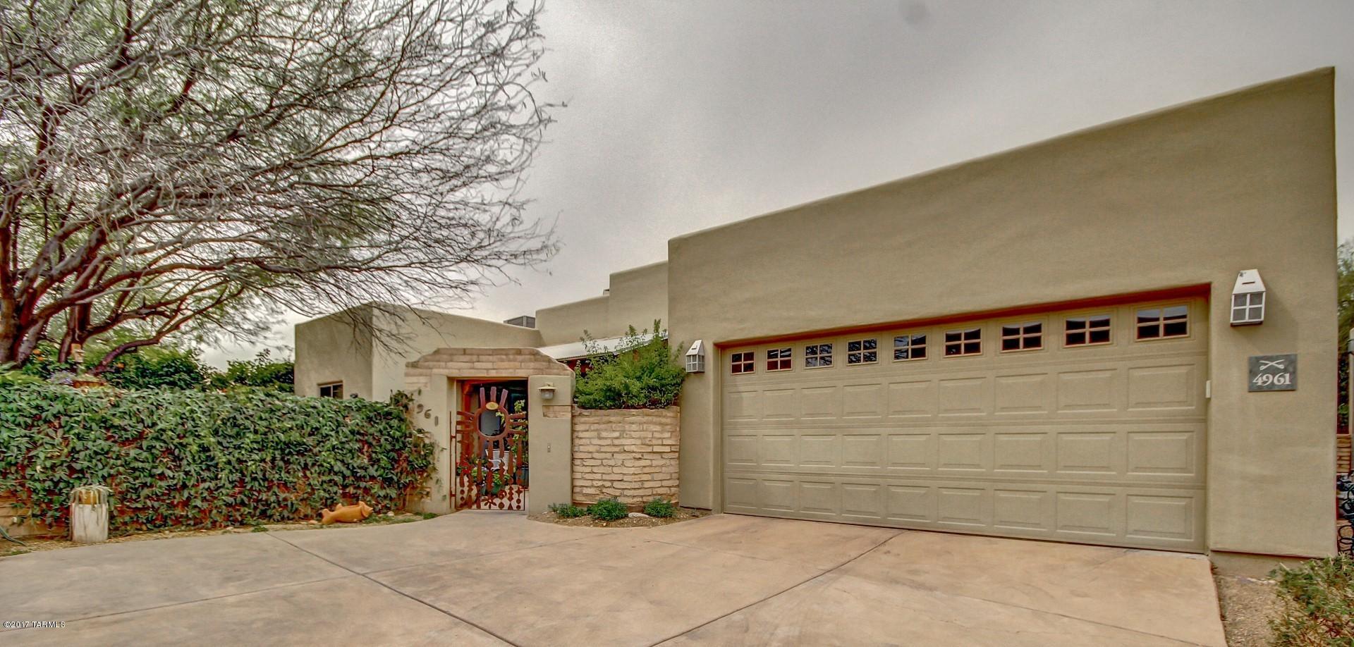 GORGEOUS SINGLE LEVEL WITH BEAUTIFUL PRIVATE COURTYARD.OPEN & SPACIOUS W/ HIGH VEGA LOG CEILINGS, STAINED CONCRETE FLOORS THROUGHOUT,  LARGE OPEN KITCHEN WITH GRANITE COUNTERTOPS AND BACKSPLASH,BRK BAR, SS APPLIANCES AND PLENTY OF CUSTOM CABINETS. PICTURE WINDOWS THROUGHOUT.LIVING ROOM W/ COZY FIREPLACE. SIZABLE BEDROOMS, ONE WITH ATTACHED FULL BATH. SPACIOUS MASTER WITH PRIVATE ACCESS TO PATIO AND EN SUITE THAT OFFERS WALK-IN CLOSET, SOAKING TUB AND SEPARATE WALK IN SHOWER, PLUS HIS AND HERS VANITY SINKS. BACKYARD IS YOUR OWN PERSONAL GARDEN OASIS TO ENJOY THE LUSH DESERT LANDSCAPING UNDERNEATH THE COVERED PATIO. CLOSE TO MAJOR STREETS & SHOPPING .