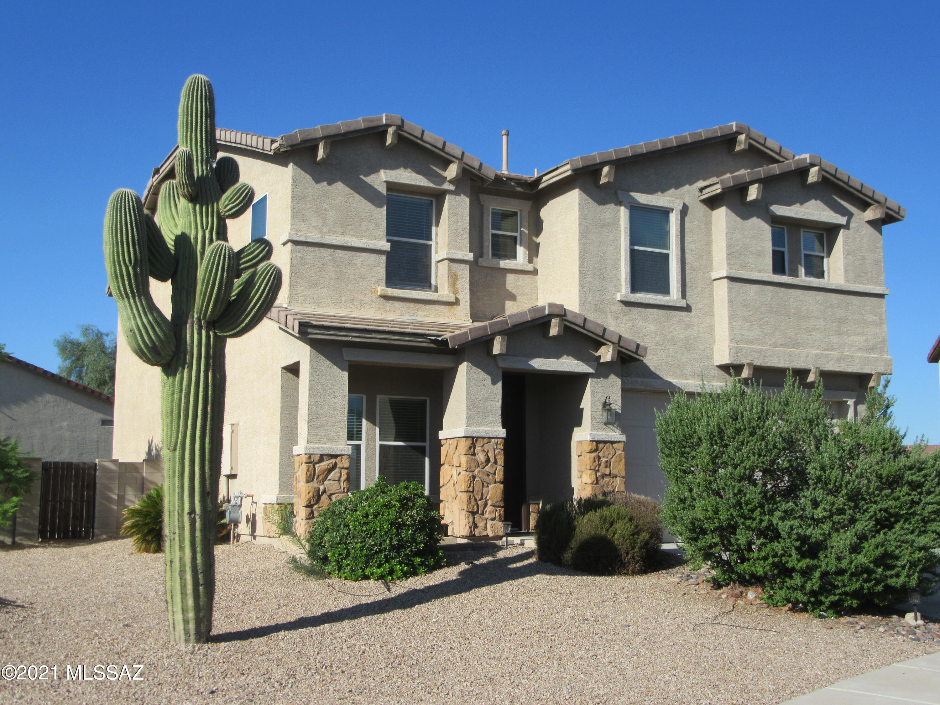 One of the largest lots in Hartman Vistas; plenty of room for a big pool!  Tucson Mountain Views from back patio and deck off of master suite.  Fresh paint and new carpet throughout. New AC compressors.  New Gas Stove.  Large bonus room upstairs could be used as an office, game room, or convert to a 5th bedroom.  3 extra bedrooms with walk-in closets.  Also a loft upstairs.  Natural cherry cabinets ,custom tile counters and breakfast bar in kitchen.  Multiple ceiling fans.  Broker is the Manager of the LLC Owner.