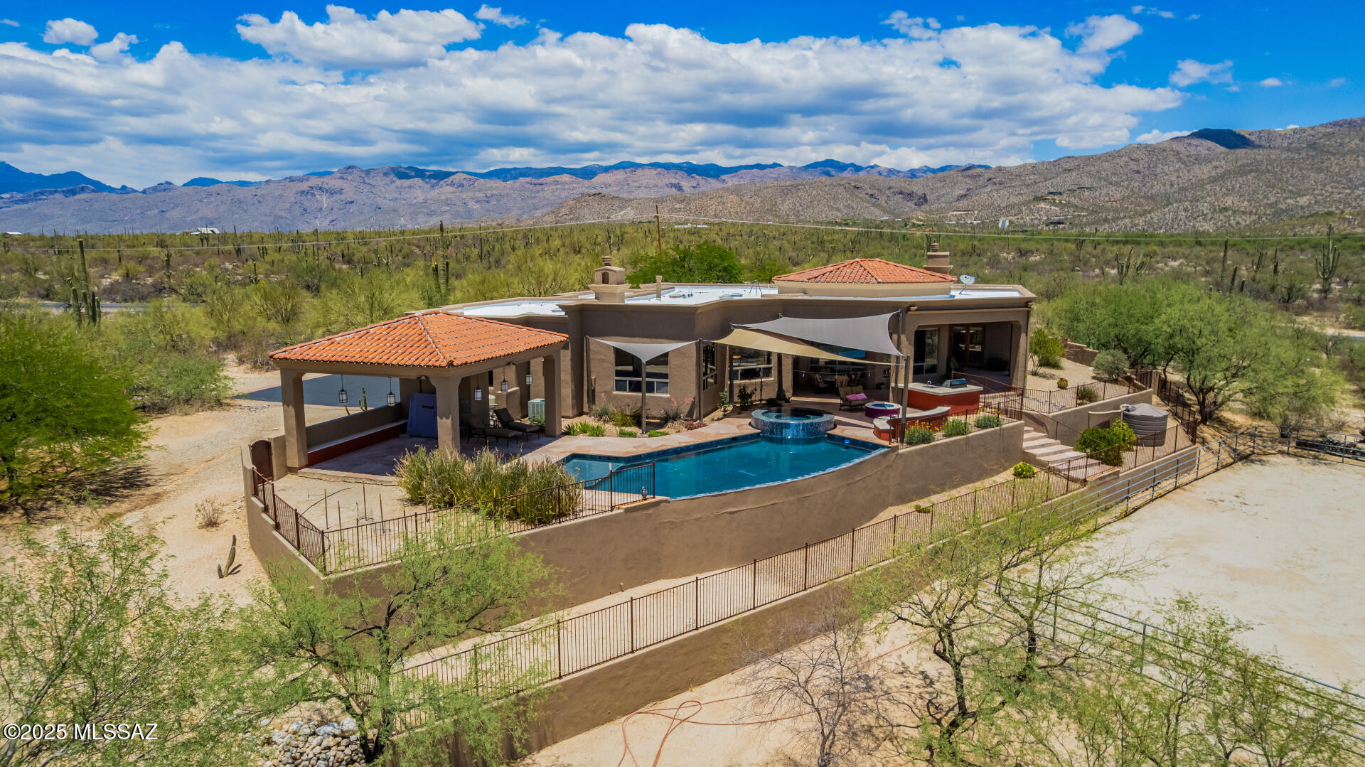 Beautifully designed custom & impeccably maintained home. This luxurious home boasts captivating expansive mountain views inside & out. The private courtyard welcomes you in to sky-high ceilings, 8' alder doors & expansive picture windows to frame the scenery & fill the home with natural light. The spacious great room features 16' ceilings and a gas fireplace, perfect for entertaining. A large chefs kitchen includes cherry cabinetry, granite countertops, a large island and GE Monogram appliances with a breakfast nook ideal for casual meals. This split floor plan home boasts 3 large bedrooms, each with their own ensuite baths, a bonus den/office & an additional ½ guest bath. Outside is an entertainers paradise where you will enjoy the flagstone patio, built-in BBQ, gas fire pit...