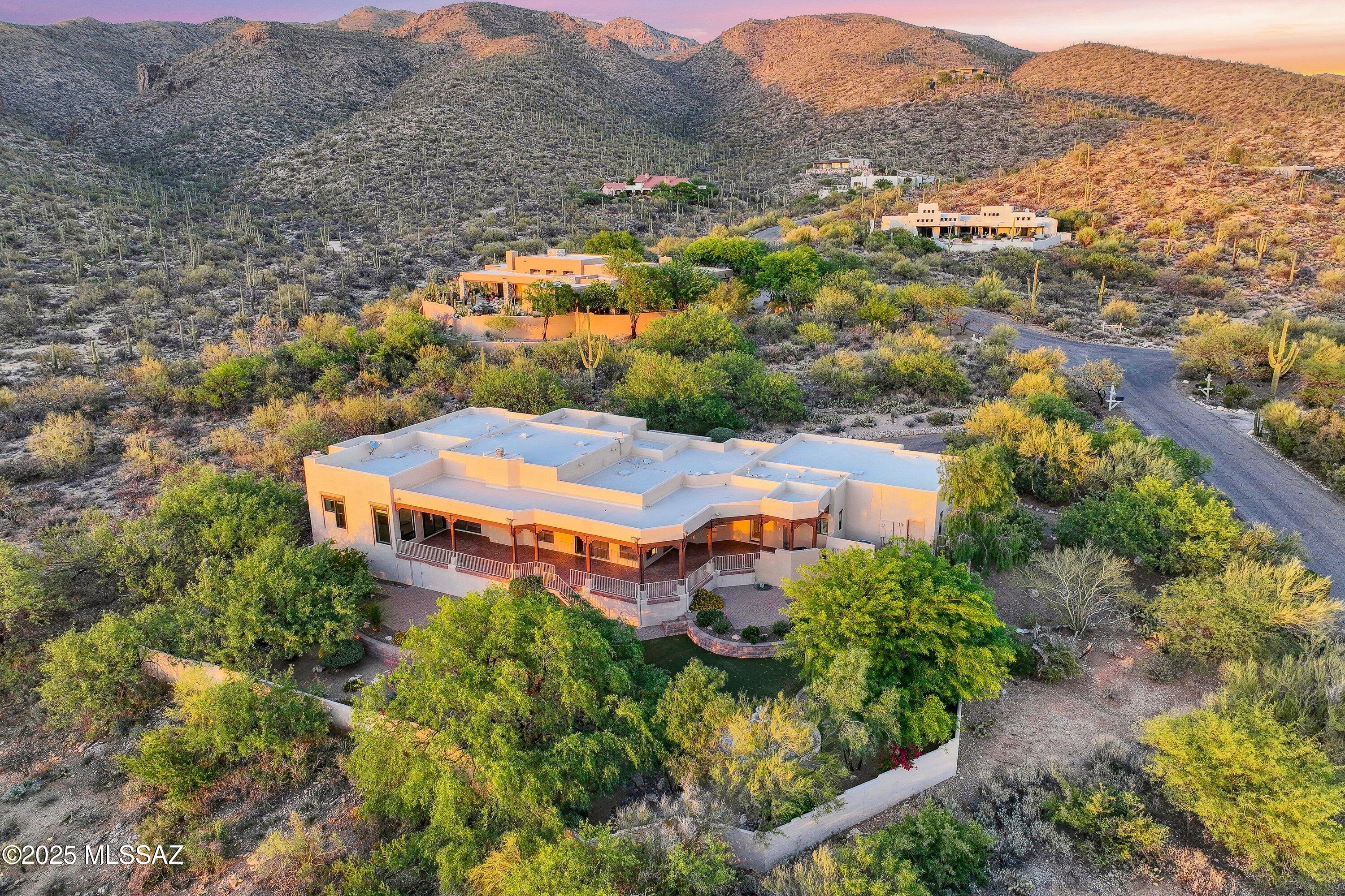 This award-winning home voted the TAR Home Tour winner by Realtors, is a rare gem in Reddington Ranch. Set on a prime lot with breathtaking west-facing views, nearly every window frames stunning mountain vistas dotted with saguaros. An expansive wrap-around patio invites you to soak in sunsets and starry skies, perfect for relaxation and entertaining. The primary suite offers a walk-in closet, fireplace, and spa-like bath. Residents enjoy exclusive amenities, including a horse stable, clubhouse, swimming pool, and tennis court.