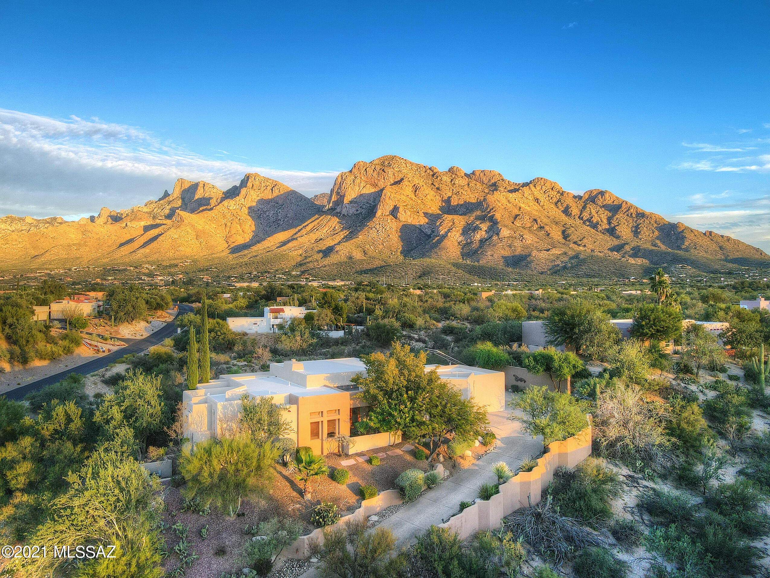 SITUATED ATOP ONE OF THE LARGEST LOTS IN ORO VALLEY COUNTRY CLUB AREA (1.4 ACRES)...THIS GORGEOUS ESTATE HAS UNOBSTRUCTED MOUNTAIN VIEWS TO THE EAST FROM BACK PATIO AND INCREDIBLE SUNSET VIEWS TO THE WEST FROM THE FRONT PATIO.  INCREDIBLE DETAIL THROUGHOUT, 4 CAR GARAGE, AND GUEST QUARTERS THAT ARE PERFECT FOR ANYTHING FROM GUESTS, TO OFFICE SPACE, TO ADDITIONAL BEDROOM(S) FOR USE WITH MAIN HOUSE BUT THE SEPARATE SPACE SOME DESIRE!  HOME HAS OWNED SOLAR SYSTEM MAKING MONTHLY UTILITY COSTS A BARGAIN!