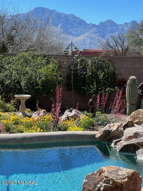 Beautiful custom home with mountain views and privacy! Country living just minutes to shopping/dining and medical. PAVED road to home on a quiet cul-de-sac in a lovely neighborhood enclave of custom homes. Gated driveway. 3 car garage. 4 bedrooms and den (split bedroom plan). Beautiful views can be seen throughout the home from the huge picturesque windows. Relax on cool days/evenings in the den by the cozy gas fireplace. Beautiful, relaxing and private backyard with pool and spa. Gorgeous knotty alder kitchen cabinets, granite countertops and stainless steel appliances. Leased solar thru Tesla. Heater is for Spa.  Pool is saltwater.