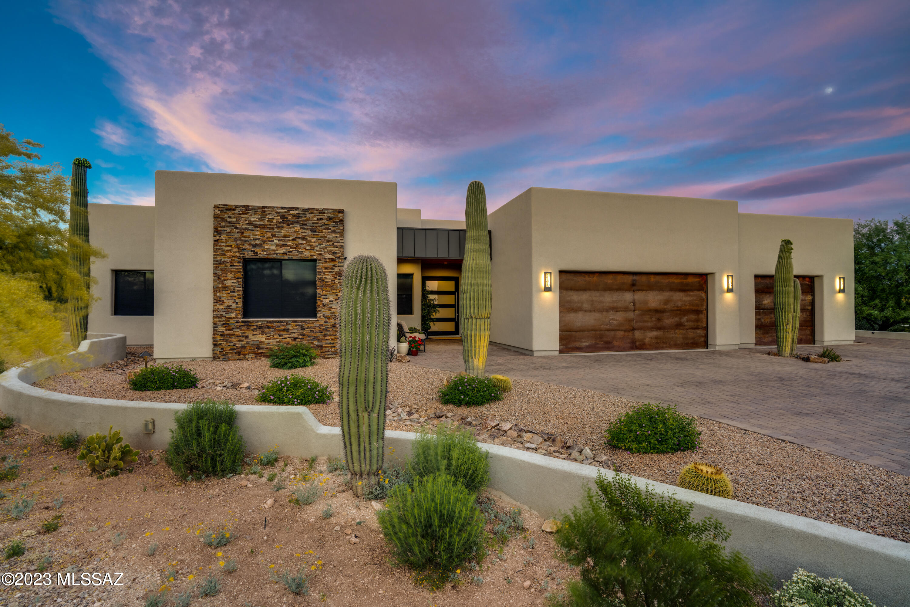 One-of-a-Kind Desert Contemporary SMARTHome with spectacular views!  The oversized sliding glass door allows for flow-free entertaining both inside and out. Gourmet kitchen with SS appliances, 2 ovens, prep sink, quartz countertops and gorgeous cabinetry comes together timelessly. The sleek and comfortable living room with fireplace surrounded by picture windows brings in big views and sunsets. The primary bedroom boasts amazing views and an enormous en suite bathroom with walk-in closets, soaking tub and more. Each guest bedroom has access to their own bathroom with stunning craftmanship.  BONUS Media Room with surround sound and wet bar!  All mounted TVs will convey with property.