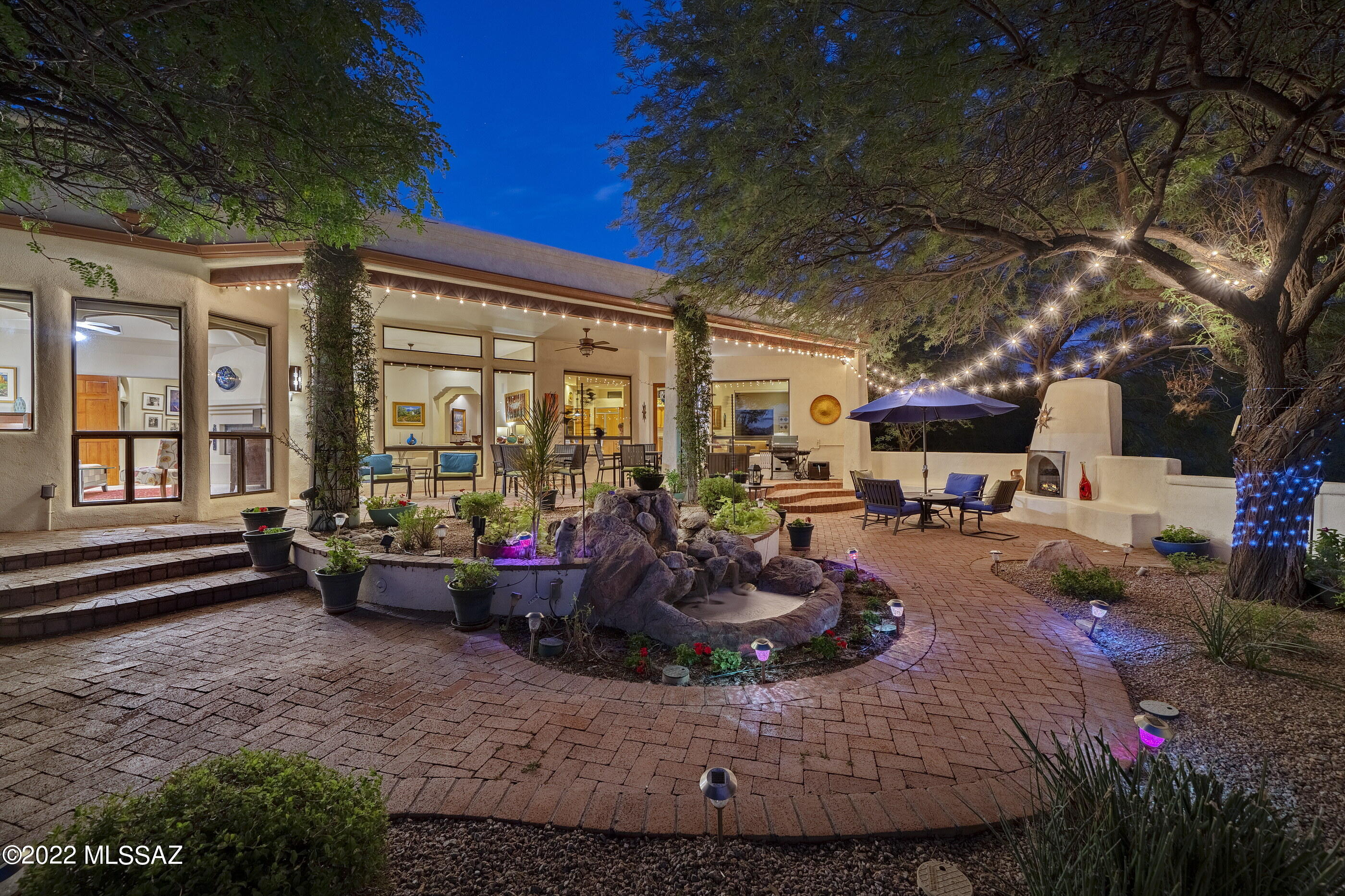Nestled on a private cul-de-sac, exuding luxury and lifestyle while surrounded by lush natural landscapes, offering views that stretch out over the city and mountains beyond. This stunning territorial vernacular home was designed to offer both scaled social spaces, ideal for entertaining, as well as the privacy of a desert retreat. Complementing this perfectly executed split bedroom floor plan, provides fluidity and openness that spills out onto the tranquil grounds at every turn.
The front courtyard leads to a foyer, which establishes the main connection point of the home and opens onto the living room and formal dining areas. The heart of the home is the fabulous chef's kitchen, featuring a classic and timeless fit and finish, which includes an array of service counter space, dressed in granite countertops, providing ample storage and set against a pro series built-in appliance package. 

Sequestered on the South end of the residence is the primary suite, with a cozy fireplace and spacious bath, featuring a custom walk-in dressing room, oversized walk-in shower, soaking tub and dual vanities. A glass door leads from the owner's suite to a walk-out patio, perfect for enjoying the breathtaking mountain and city views to the South. The balance of three bedrooms are situated on the North wing of the residence, perfect for families and guests alike. 

The elongated veranda connects the shared living spaces, with a series of doors coordinated to tie the interior rooms to the spacious outdoor living environments. Seamless indoor-outdoor entertaining while out on the sun-drenched South facing veranda, features a soothing water element, providing perfect Southeast orientation that offers passive solar heating during the cool winter months, while providing full shade and enjoyment year round.

This property is perfectly located within minutes to La Encantada shopping center, fine dining, and La Paloma Country Club with world class tennis facilities, fitness, a 27 hole Jack Nicklaus designed golf course managed by Troon, and a resort pool complex.