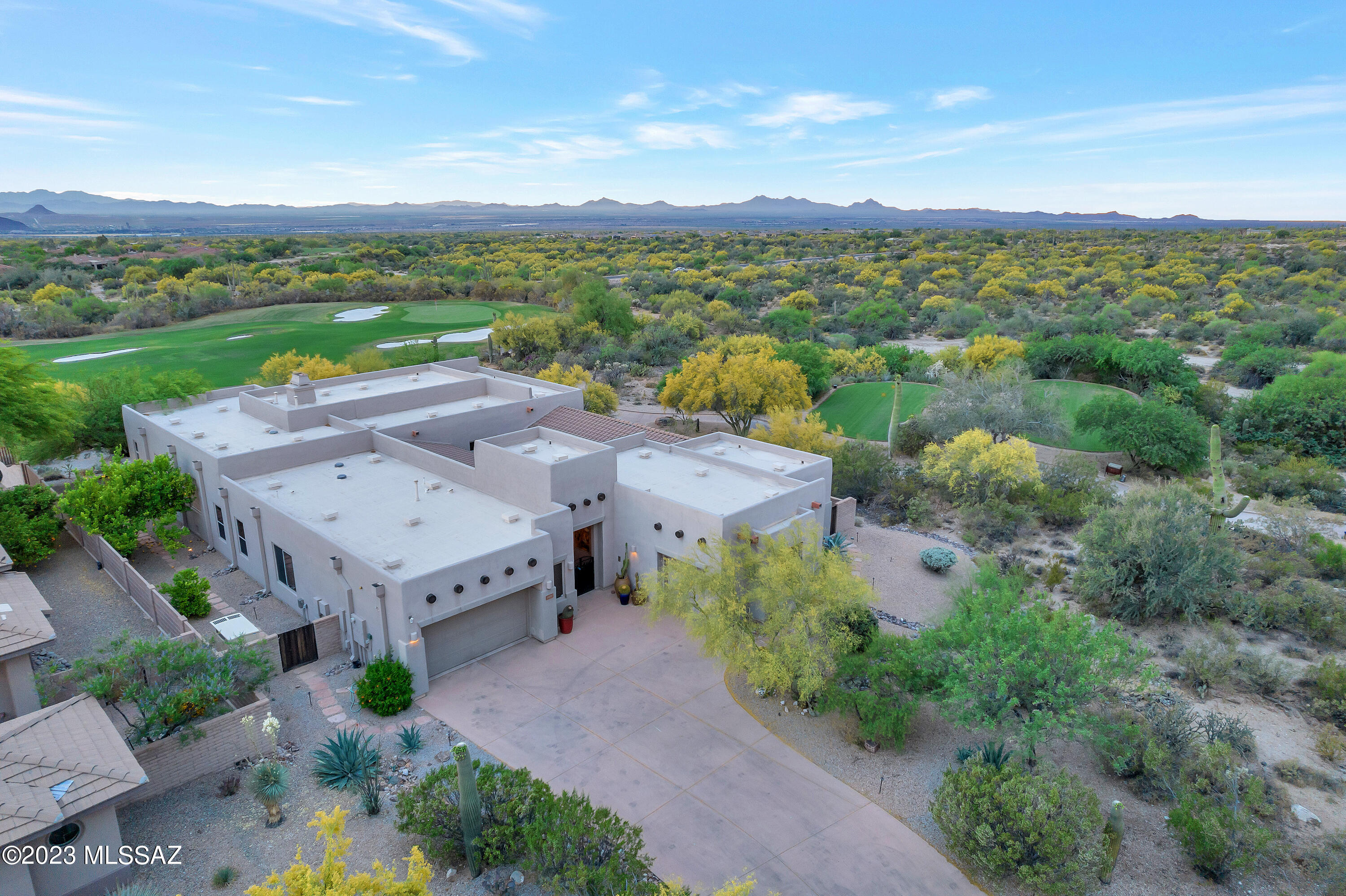 Welcome to this exquisite home nestled in the gated community of the Gallery at Dove Mountain and situated at the end of a tranquil cul-de-sac. Breathtaking sunset & desert views & overlooking the 11th  fairway of the scenic golf course from the back patio.  The main house features 3 BRS, 2.5 bathrooms, + a den. The GH provides an additional BR and BA with a small kitchenette. Tile flooring, wet bar. 4 fireplaces and high beamed ceilings. The kitchen showcases high-end Dacor, Viking, and Subzero appliances. An elongated island and prep area offer ample space for casual entertaining. The kitchen area seamlessly opens to the shady courtyard, with a built-in BBQ & a refreshing pool.    The generous owner's suite features an additional sitting area and a large walk-in closet. The Gallery at Dove Mountain community offers a wealth of amenities, including golf, tennis, and a clubhouse, providing a luxurious and active lifestyle for its residents. With its stunning views, exceptional features, and prime location, this home is an opportunity not to be missed.