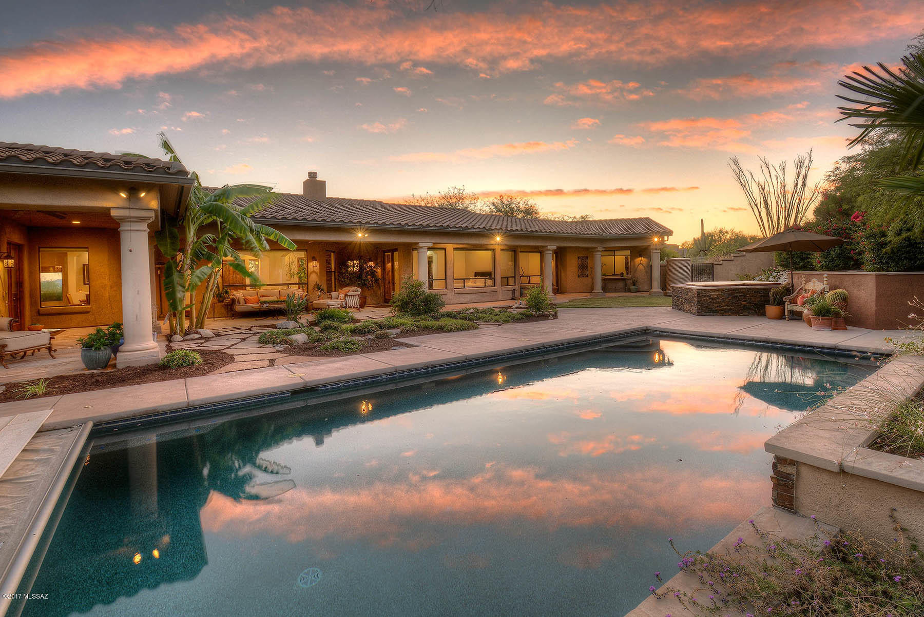 Magnificent custom home built in 2007 looks brand new features gleaming Brazilian mesquite floors, fantastic split plan, game rm, attached guest house, loaded chef's kitchen w/Wolf range &Subzero fridge , formal & informal dining, home office, studio/den, luxurious master suite, all en suite baths, glorious mountain and city VIEWS, stunning landscape incl grove of fruit trees (apricot, bananna, pear, grapefruit & more).  Custom crafted with beautiful finishes & perfect for family living.  LOCATION is amazing; La Encantada is .5 mile away & Banner/UMC is a straight shot down Campbell.  Small gated community RARELY has home for sale - enjoy views from practically every room  - or relax on the deep shady porch after a dip in the lovely pool  Best in the foothills in this price point - WOW!
