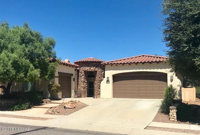 Welcome to this beautiful 3 bedroom, 2 bath, 3 car garage home in AWARD winning Rancho Sahuarita located 1 block from the neighborhood lake. This home offers beautiful laminate floors in the main areas, 10 foot ceilings, split floor-plan and an open concept that's perfect to entertain friends and family. The master retreat has a wall of windows that brings in lots of natural light and a large bathroom that has a separate shower, soaker tub, and walk-in closet. The backyard can be your relaxing space after a long day. Run your toes thru the grass, hop in your hot tub, or just sit back and enjoy the sunset. This one has what you need to call it HOME.