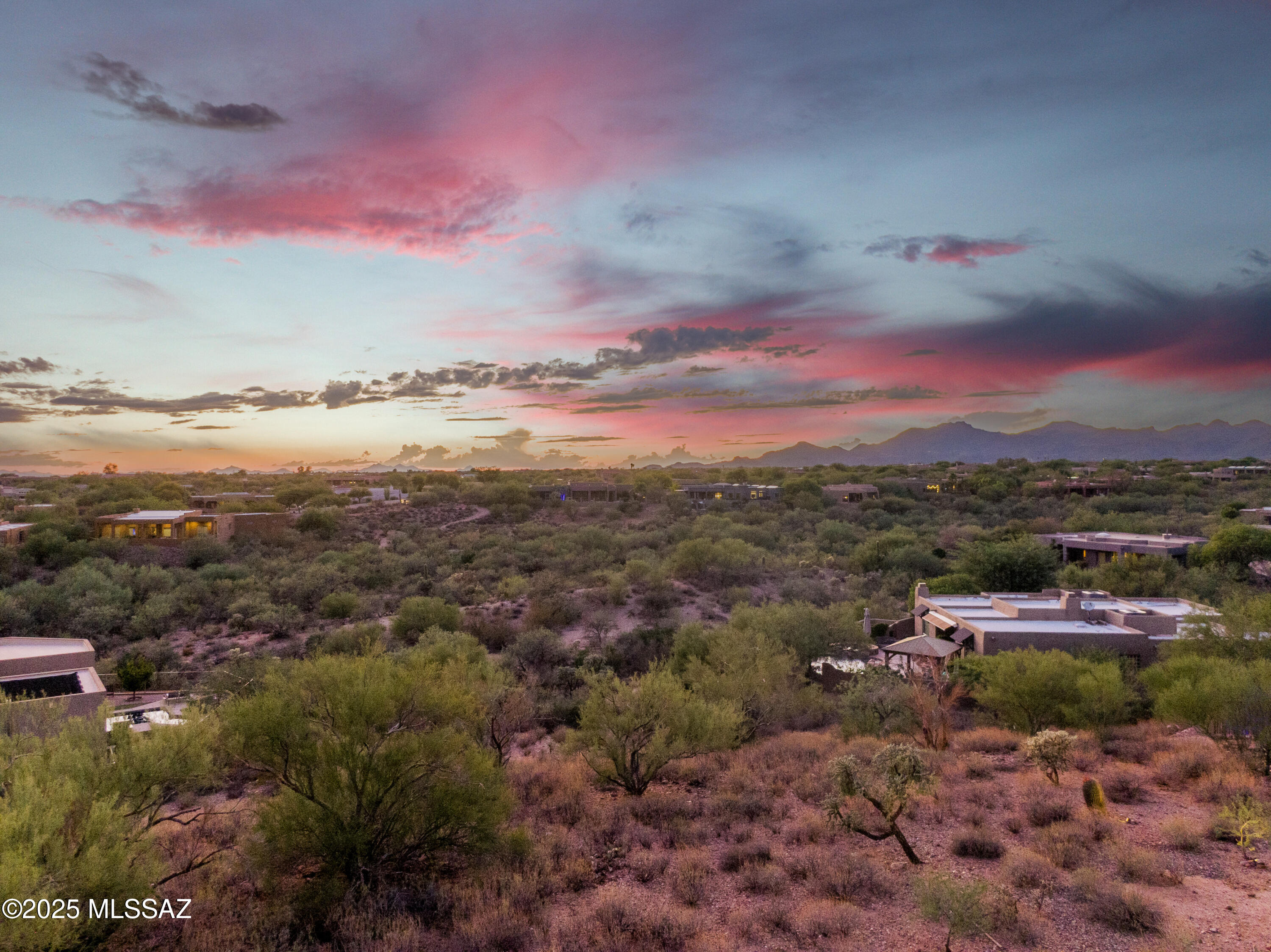 Discover a rare opportunity to build a custom home in the prestigious Sunridge II community in Oro Valley. Situated at a privileged and elevated position, this lot provides long range views to the Catalina Mountains to the East and Unobstructed sunset views of the Tortolita mountains to the West.  Builder approved renderings of a single-story 2,563 sqft. property is included to understand the size and scope of the build.  Sunridge II is a mature and established neighborhood, celebrated for its custom homes and breathtaking scenery and sits at a high point within the Oro Valley community. Lifestyle and convenience from this location are dynamic. Cyclists and runners have near immediate access to "The Loop" multi-use paved path along Tangerine Road. Incredible mountain biking and hiking can be found at the nearby Big Wash Trailhead and Catalina State Park. Three golf clubs are within a 10-minute radius. Plus, The Oro Valley Marketplace with shopping, dining, indoor pickleball, movies, medical services and fitness facilities are all close by.