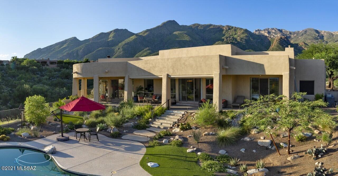 Beautiful Catalina Mountains & City Lights enhance this updated Contemporary Foothills home. Quiet cul-de-sac location bordering common area for the privacy you are looking for. Gorgeous remodeled kitchen overlooks the family room and offers a large island, breakfast nook, beautiful granite counters, induction cooktop & contemporary cabinetry w/clean lines. Split bedroom plan. Master Suite & office/den at one end separated from other 3 bedrooms. Remodeled Master Bath w/dual vanities, separate soaking tub, lg walk-in shower, & 2-sided Fireplace. Generous Great Room, High Ceilings and enormous Window Walls/Sliders across entire South side of home allow for lots of Natural Light and Views!  Inviting Negative Edge Pool/Spa, professionally landscaped yard & huge covered patio for outdoor  livin