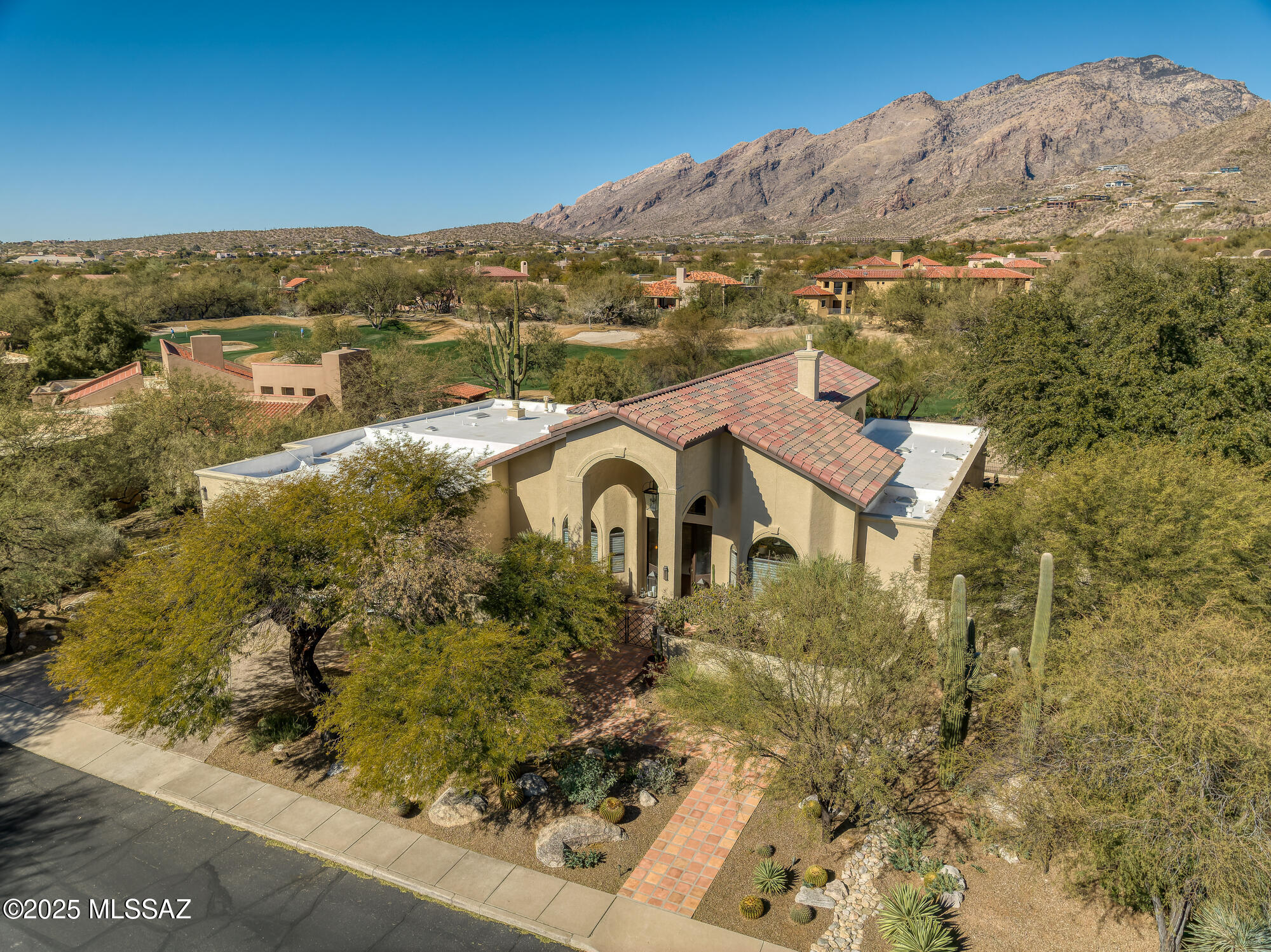 One Level, Updated, 4BR & 4BA Contemporary Home On the Golf Course  in The Exclusive Gated Community of Ventana Canyon. Meticulously Maintained and Thoughtfully Updated By Lori Carroll & Assoc. Fine Features Include: Grand Courtyard Entry w/Custom Metal & Glass Front Door - Vaulted Ceiling Foyer & Main Living Areas- High Shine Travertine Floors Throughout - Island Kitchen w/Stainless SubZero & Thermador Appliance all Opening to Great Room w/Designer Stone Fireplace & Wall of Windows - Spacious Primary Suite w/Exercise Rm, Sitting Area, Fireplace,Sweeping Mountain Views,Walk In Closet, & Spa Like Bath w/Jetted Tub - Private Outdoor Living w/Hidden Above Ground Hot Tub, Water Feature, Outdoor Kitchen, Gas Fireplace, & Sweeping Mountain and Golf Views - Coveted 3 Car Garage+Golf Cart Garage.
