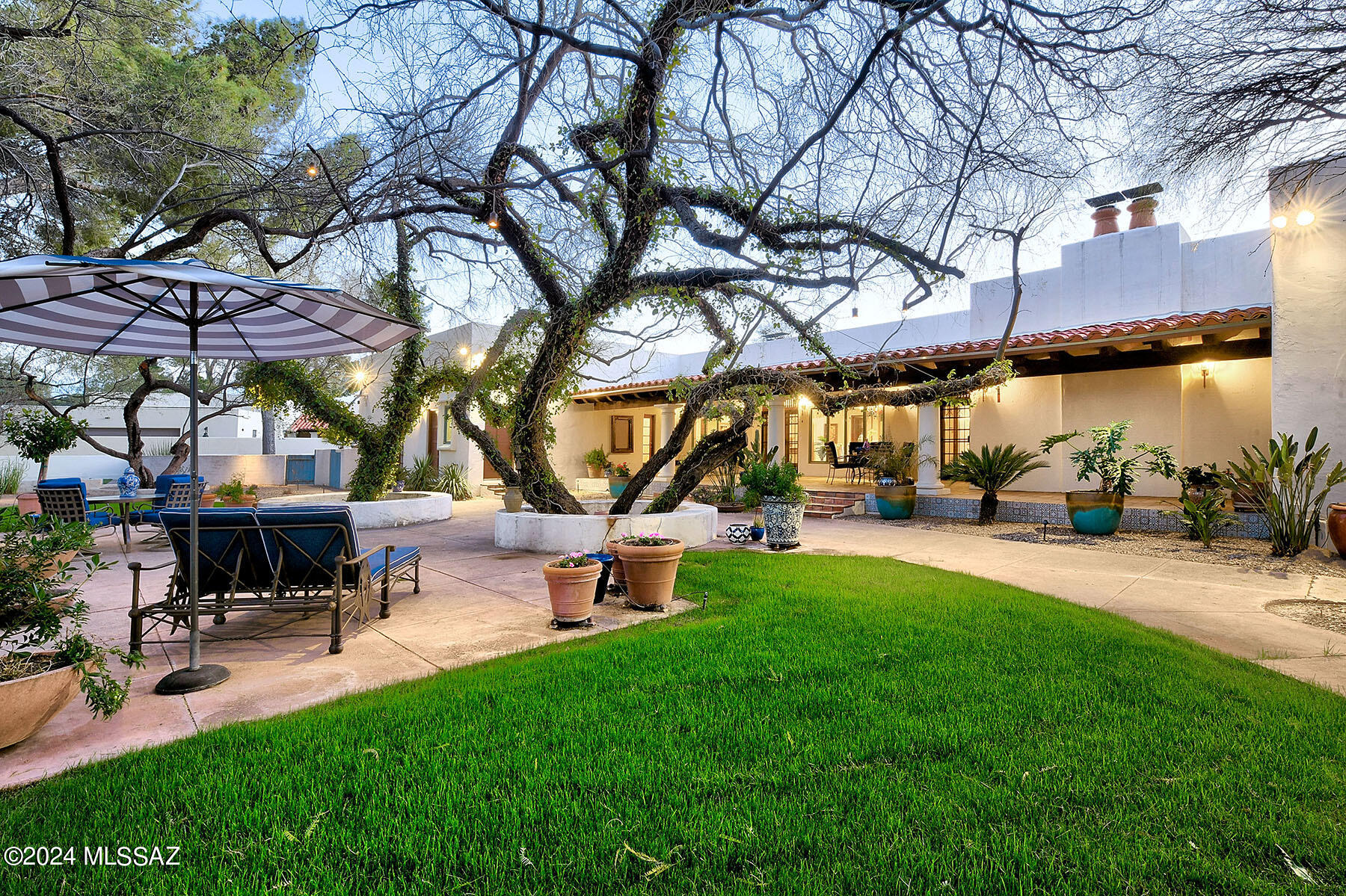 Gracious and Sophisticated Spanish Mission Style Home with mountain views situated on a corner homesite in the prestigious guard gated Tucson Country Club. Beautiful foyer gallery entry with high beam ceilings, exquisite living room with French doors to a side patio w/ fireplace, formal dining room, gourmet island kitchen w/ decorator tile and stainless steel countertops, gas stove top, double ovens, Sub Zero, butlers pantry w/sink, lovely breakfast 
area, beautiful tile floors and French doors throughout, 5 bedrooms plus den/study and an exercise room, laundry room & oversized 2 car garage. Enjoy the fabulous backyard with large covered patio, grass, mature trees, lush landscaping, circular driveway and mountain views.