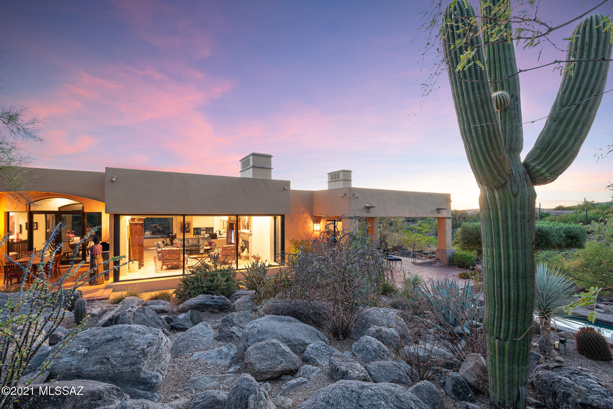 Exceptional custom home on a 1-acre lot w/ up-close mountain views located at the top of the saguaro-studded Catalina Mountain foothills in gated Canyon View Estates. Situated btw Ventana Canyon & Sabino Canyon, this lush desert homesite provides the best of Tucson landscape, views & lifestyle.  Enter through a custom gate to an expansive courtyard w/ shady mesquite trees. Bright & open floor plan w/ walls of windows, high quality materials & finishes throughout.  Great room w/ cantera fireplace, formal dining area & study/office area all w/ honed flagstones floors. Enjoy the best of the indoor/outdoor Arizona lifestyle with an outdoor dining room w/ built-in BBQ  just off the kitchen on one of many deep covered brick patios that surround this home. CLICK MORE Recent kitchen remodel with custom cabinetry, center island with wine refrigerator, stainless steel sub-zero refrigerator/freezer, bosch dishwasher and microwave, viking 6-burner oven/cooktop with hood vent, caesar stone and granite counters and custom travertine backsplash.  Large custom built buffet provides extra storage.  Spacious breakfast area with views of the desert and the mountains to the north through large windows. Elegant master suite with dramatic fireplace, his and hers closets and gorgeous views.  French doors lead to a private brick covered patio. Generous sized, spa-like master bath with separate dual vanities, large steam shower and soaking tub.  Second master bedroom serves as luxurious guest suite with upgraded en-suite bathroom. Third bedroom/office provides flexible space.  Oversized laundry room with tons of storage is perfect for mud-room, pantry or whatever you may need. Resort style backyard strikes an ideal balance of nature and modern amenities with a lap pool with cantera border surrounded by cacti and native plants and multiple private patios and areas to dine or enjoy a book.  2-car garage has large storage room. North/South Exposure. District #16 schools minutes from this home.  Property located within minutes of Sabino Canyon Park, Ventana Canyon Resort and Country Club and other world-class golf resorts and fine restaurants and shopping.