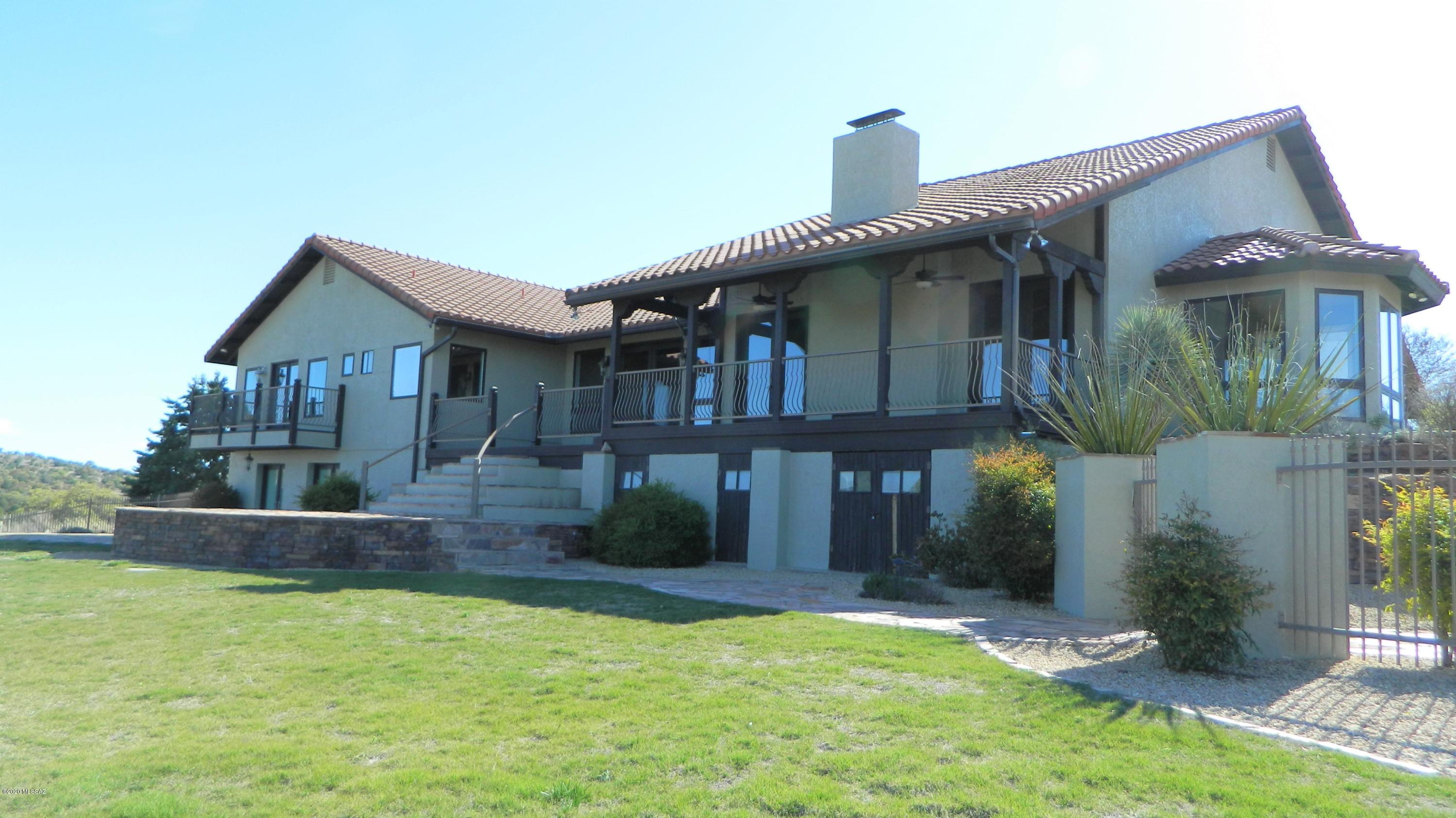 Exquisite Country Estate on 216 acres surrounded by Nat'l Forest in the heart of SE AZ wine & ranch country. Located in the oak studded Canelo hills. Built in 1990 and completely remodeled in 2005, this stunning home has formal living & dining rooms, spacious family room, vaulted beamed ceilings, dramatic arches, lovely Saltillo tile floors, and hammered copper sinks in bathrooms Gourmet kitchen w/2 dishwashers, chef's range, built-in espresso maker, & rough-edged granite counters. In addiiton to the living/dining areas, the main floor features 4bd/3 full baths & 2 powder rooms.  Lower level w/Great Room, full kitchen and bath.   Land has  2 stall barn & cross-fencing.  Potential Vineyard, Equestrian Estate, Family Retreat, B&B.  Partially furnished while owners are in process of relocatin