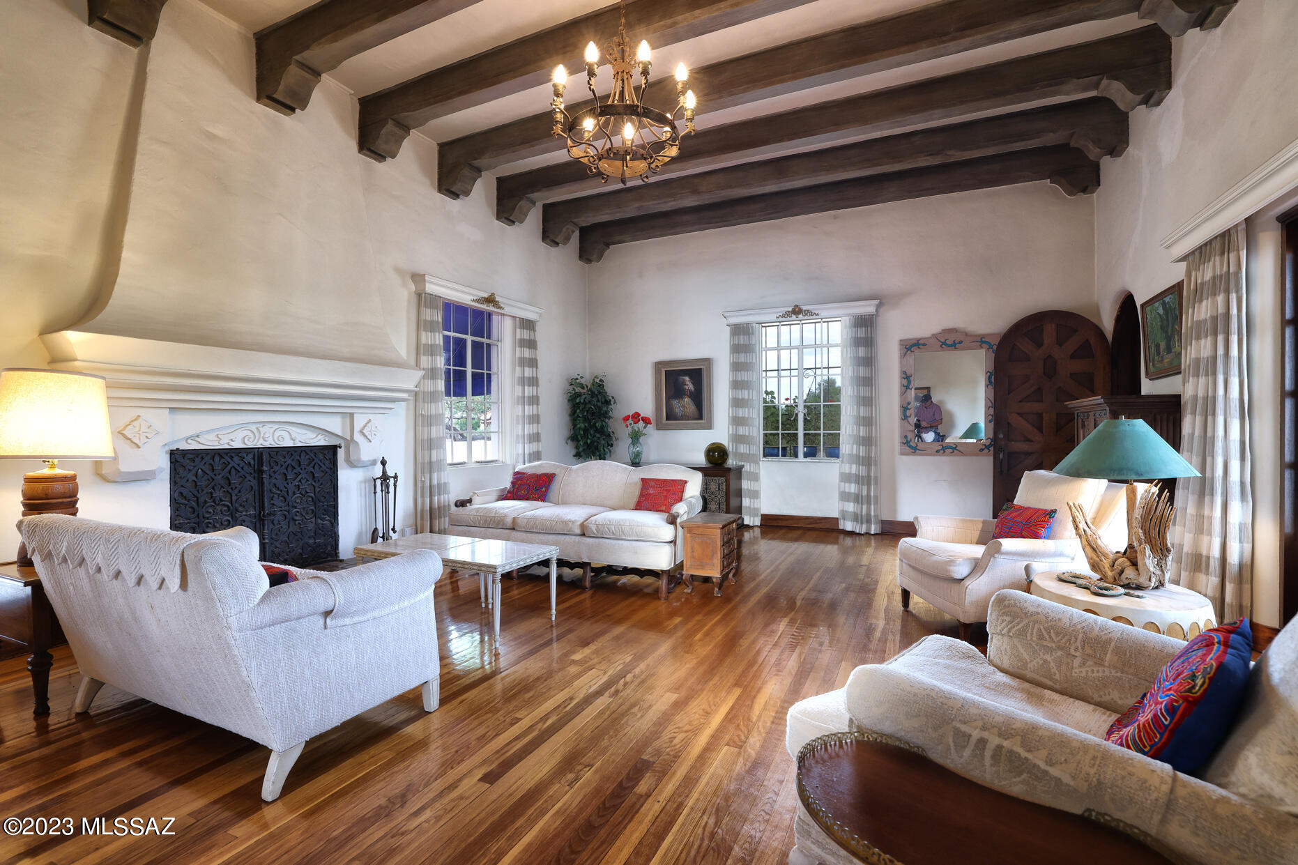 Lovingly Maintained Home with Tremendous Character & Attention to Detail, Located in Sought After, Historic Sam Hughes Community. Designed by Renowned Architect & Mayor, Henry O. Jaastad & Built in 1929. The Home Still Maintains some Original Hardware, Hardwood Flooring and Mahogony Doors & Beams from that time. Beautiful Gardens, Porches & Patios Surround the Home, Guest House, 2-Car Garage and Workshop, Creating a Tranquil Central Setting. 2,025 SqFt Main Home has Magnificent Living Room with Wood Burning Fireplace, High Ceilings with Mahogony Beams and Double Doors to a ''Secret Garden.'' Primary Suite is Bright due to Numerous Windows & French Doors leading to Patio. Creative Niches Inside & Out add to the Sophisticated Style. .........................

THE PROPERTY
>	Prestigious Sam Hughes Neighborhood in the Heart of Tucson
>	2,025 Sq Ft Main House, 517 Sq Ft Guest House, 130 Sq Ft Studio, 2-Car Garage
>	3 Lots Totaling .45 Acres
>	May be possible to Split Lots, if desired
>	Beautifully Landscaped Grounds with Flower Beds, Trees, and Grass
>	Inviting Entry Courtyard with Wood Burning Fireplace Surrounded by Custom Vintage Tiles 
>	Separate Studio/Workshop with Wrap-Around Porch
>	Covered Ramada/Conversation Area with Cut-out Plant Shelves
>	Decorative Security Gates
>	Heated/Cooled 2-Car Garage
>	Covered Carport Parking Space 
>	Roof Maintenance and Coating performed in 2023
>	Circular Drive 
>	Plenty of Space for Home Addition
>	Near Himmel Park and Library
>	Near Sam Hughes Elementary School
>	Near the University of Arizona Campus

MAIN HOUSE
>	2,025 Sq Ft Classic Mission Style Home 
>	Designed by Renowned Architect Henry O. Jaastad
>	Built in 1929
>	Solid Double Brick Construction
>	Original Hardwood Flooring Throughout 
>	All Original Mahogany Interior Doors with Mahogany Door Frames and Baseboards
>	Double-Hinged Swinging Doors to Kitchen
>	Interior Arched Doorways
>	Artistic Niches
>	Original Historic Hardware
>	2 Bedrooms and 1 Bathroom 
>	Magnificent Beamed Ceiling and Wood Burning Fireplace in Living Room
>	Hand-Crafted Mahogany French Doors Leading to Secret Garden from Living Room
>	Built-in Bookcases and Desk in Family Room 
>	Dining Area with French Doors to Front Patio
>	Galley Style Kitchen with Gas Cooktop
>	Tile Counters and Backsplash 
>	New Garbage Disposal
>	Pantry Closet
>	Bright Master Bedroom with Doors to Patio and Back Yard
>	Vintage Tiled Bathroom with Tub/Shower Combo
>	Bathroom Cabinets with Pullouts 
>	Private Covered Patio and Gate to Secret Garden
>	Laundry Room with Original Vintage Milk Delivery Door
>	2nd Bedroom on Lower Level with Cedar Closet 
>	Storage Room or Fitness Room also on Lower Level
>	New Heat Pump 2022

GUEST HOUSE (517 Sq Ft) 
>	1 Bedroom and 1 Bathroom
>	Bedroom/Living Area
>	Bathroom with Clawfoot Tub and Pedestal Sink
>	Kitchen has Full-Size Refrigerator
>	Large Counter with Sink and Tiled Backsplash
>	Built-in Cabinets in Living Area
>	Covered Patio
>	Private Entrance through Back Yard
>	Saltillo Tile Flooring
>	New HVAC 2020