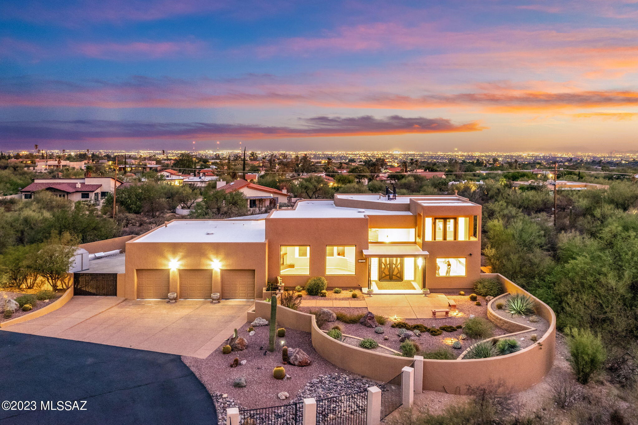 Seller is licensed to sell real estate in the state of Arizona. Welcome to your future oasis! Approaching this incredible home, you'll be greeted by a large front courtyard with an exposed aggregate concrete walkway, setting the stage for the warm and inviting atmosphere that awaits you inside. Captivating views await you inside and out! With vistas of the majestic Catalina Mountains and the sparkling cityscape, this home is a true gem for those who appreciate the beauty of nature and the excitement of city living. Step inside and instantly feel the ''wow'' factor that comes with the vast, light-filled spaces and enormous windows showcasing breathtaking mountain views -  a perpetual painting of natural splendor! The main level offers 3 bedrooms, plus a den & an additional bonus room. As you ascend to the second level, you'll find your private sanctuary - a luxurious bedroom and a convenient office, perfect for taking in the views while you work or simply unwind in peace.

Calling all car and outdoor enthusiasts - this property has got you covered! The three-car garage with additional storage space is ideal for keeping your recreational toys, be it a boat or any other fun vehicles, safely and securely. Plus, with the durable steel construction, you can rest assured that your home is built to last. The additional workshop in the backyard allows all the space you need for your projects and interests.

Indulge your culinary passions in the beautiful kitchen, adorned with Italian porcelain tile and topped with elegant quartz countertops. The adjacent, light-filled dining room creates a cozy and charming ambiance for enjoying delicious meals with loved ones.

The heart of the home, the family room, is designed to maximize those awe-inspiring mountain views, flooding the space with natural light and creating the perfect spot for relaxation and gatherings.

Ease and convenience are at your fingertips with the central vacuum system, ensuring that maintaining this beautiful abode is a breeze.

Your private retreat awaits in the primary bedroom, complete with a safe for your valuables and French doors leading to the back patio. The remodeled primary bathroom is an oasis of modern luxury, and the large closet provides ample space for your wardrobe.

Picture yourself on the loft balcony, gazing at the city lights twinkling in the distance, and you'll know that this is the place you've been searching for. The location is ideal, just a short drive from all the amenities you could wish for, making it convenient to access everything you need while still enjoying your private sanctuary.

The outdoor space is an entertainer's dream, with a rooftop deck offering sweeping views, perfect for gatherings and celebrations. The double gate to the backyard allows easy access to store your recreational toys, ensuring you're always ready for your next adventure.

Imagine cozying up by the wood-burning fireplace in the covered barbecue area, creating memories with friends and family. The extended covered patio invites you to relax and enjoy the tranquility of the surrounding nature.

If you love nature's symphony, you'll be enchanted by the peacefulness of the back balcony, where the songs of various birds will be the soundtrack to your relaxation.

This remarkable home offers an abundance of storage, so you can keep everything organized and ready for your next adventure. It's truly a haven for discerning buyers seeking the perfect blend of breathtaking views, modern comforts, and ample space for all their hobbies and toys.

Don't miss the chance to make this dream home yours - it's the perfect place to create lasting memories with loved ones and experience the joy of living amidst the beauty of nature and the excitement of city life. Welcome home!