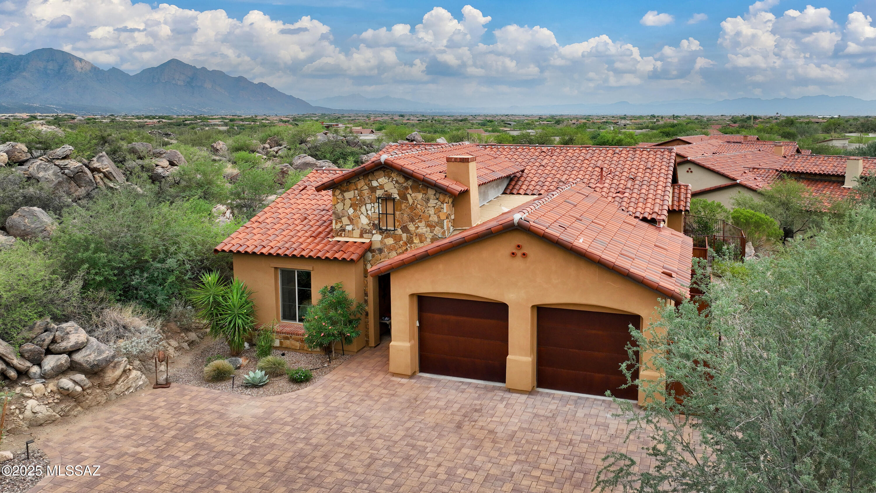 This like-new Stone Canyon golf casita is situated on one of the best casita lots offering a beautiful setting, amazing views, and privacy, The interior features a neutral color palette set against the warm wood-look plank flooring. The private exterior features a spool, water feature, rock-outcroppings, built in BBQ, and very cool firepit on top of the outcropping with amazing views of the Catalina Mountains & Tucson city lights. The beautiful setting and convenient location have made the Stone Canyon golf casitas very popular;  just a short walk to the clubhouse, restaurant, golf course, and fitness center. Stone Canyon is a private guard-gated community ranked among TOP 3 in AZ and TOP 100 RESIDENTIAL GOLF COURSES in the country. 1,942 Sq Ft, 3 Bed, 3 Bath, Wolf and SubZero appliances.