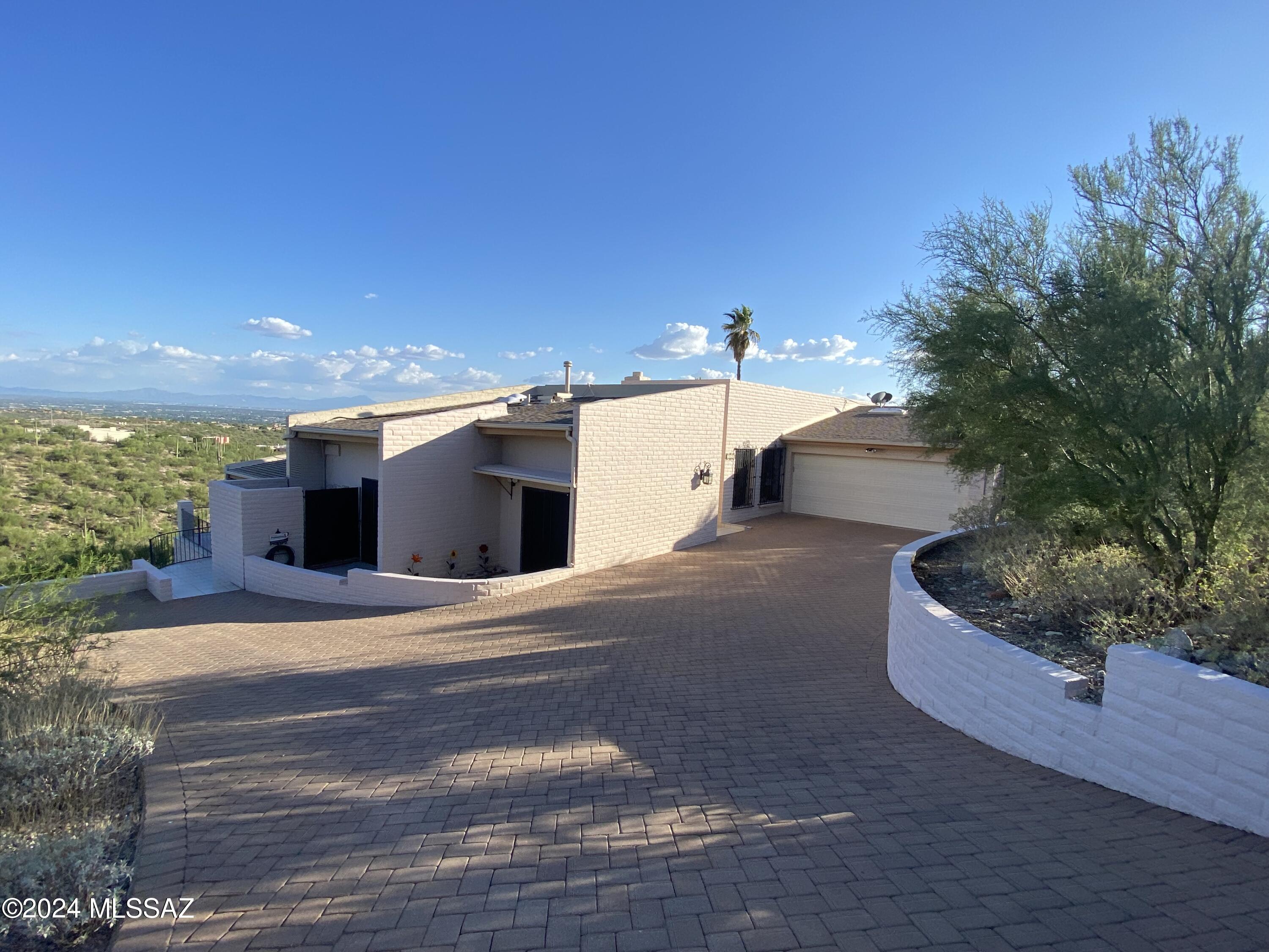Sweeping views Mountain and City Views. This hillside estate is located in the desired Cimarron Foothills Estates.  Incredible tiered floorplan affords spacious living on a luxurious level. Gorgeous custom contemporary built home  with Italian Tile flooring, Vaulted Ceilings, Muli-tiered Living Areas and a expansive Deck that affords unlimited views from every room., One of the Sellers is a Licensed Real Estate Agent in the Stae of Arizona.