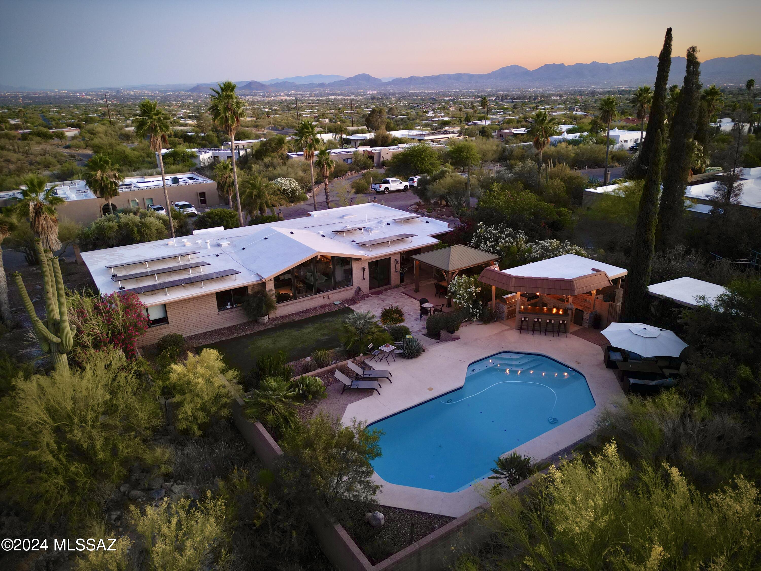 Welcome to your dream home nestled in the prestigious Catalina Foothills of Tucson! This stunning property offers remarkable mountain views that will take your breath away, all from the comfort of your entertainer's backyard. Imagine hosting unforgettable gatherings with friends and family as you take in the panoramic vistas of the majestic Catalina Mountains. Step inside to discover a beautifully remodeled kitchen, designed with the modern entertainer in mind. Featuring top-of-the-line appliances, sleek countertops, and ample storage, this kitchen is both functional and stylish, perfect for preparing gourmet meals or casual snacks. The open floor plan flows seamlessly into the spacious living and dining areas, making it easy to entertain guests while enjoying the stunning views large picture windows. The bathrooms have also been meticulously updated, offering a spa-like retreat with luxurious finishes and fixtures. Each detail has been carefully selected to provide comfort and elegance, creating a serene oasis for you and your guests. Outside, the backyard is a true entertainer's paradise. With multiple seating areas, a built-in barbecue, and a sparkling pool, this space is designed for hosting everything from intimate gatherings to large celebrations. Enjoy the tranquility of the desert landscape and the ever-changing colors of the mountains as the sunsets. This Catalina Foothills gem combines luxury, comfort, and unbeatable views, making it the perfect place to call home. Don't miss the opportunity to experience this exceptional property for yourself.