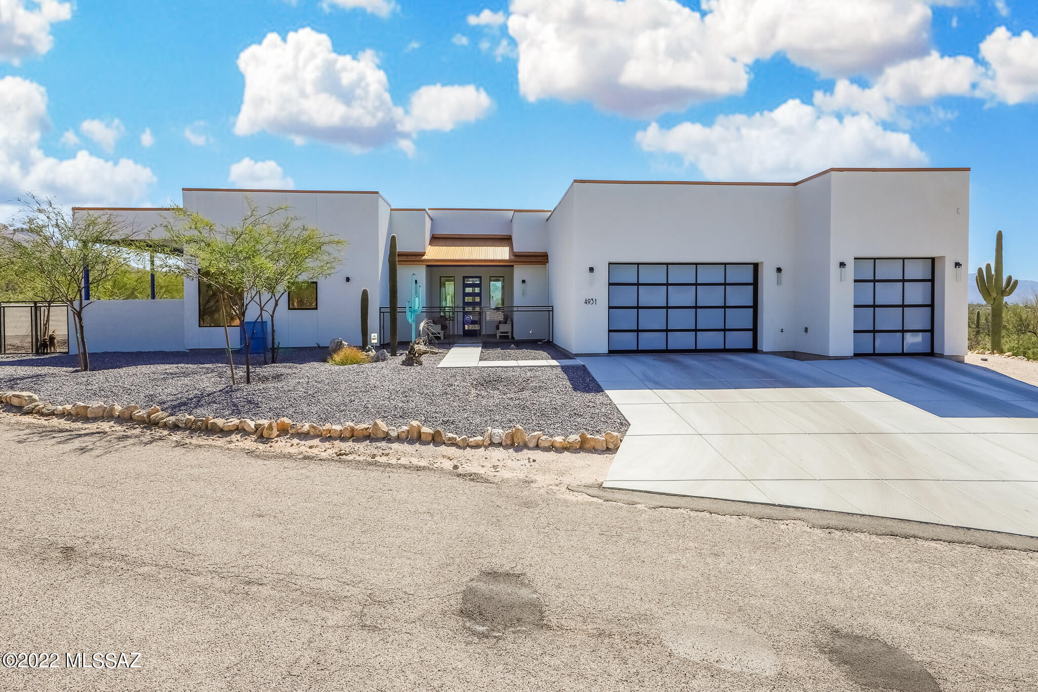 This 3494 sqft custom built home on 3.31 acres is the Oasis in the desert you've been looking for.  Surrounded by natural Sonoran Desert landscape and nestled into the foothills of the Catalina mountains you will enjoy 360-degree views from this elevated lot.  Enjoy cooking in this gourmet style kitchen with large island and Quartz countertops.  The great room is perfect for entertaining and has three different patios connected to it.  This home features a split bedroom plan with two Master Suites.  The additional 2 rooms can be used as extra bedrooms or offices depending on your needs.  The Master Suite has 2 patios, walk in shower, separate vanities, a soaking tub, and large walk-in closet.  This property is only 2 years old and needs nothing.  Come enjoy your move in ready Desert Oasis!