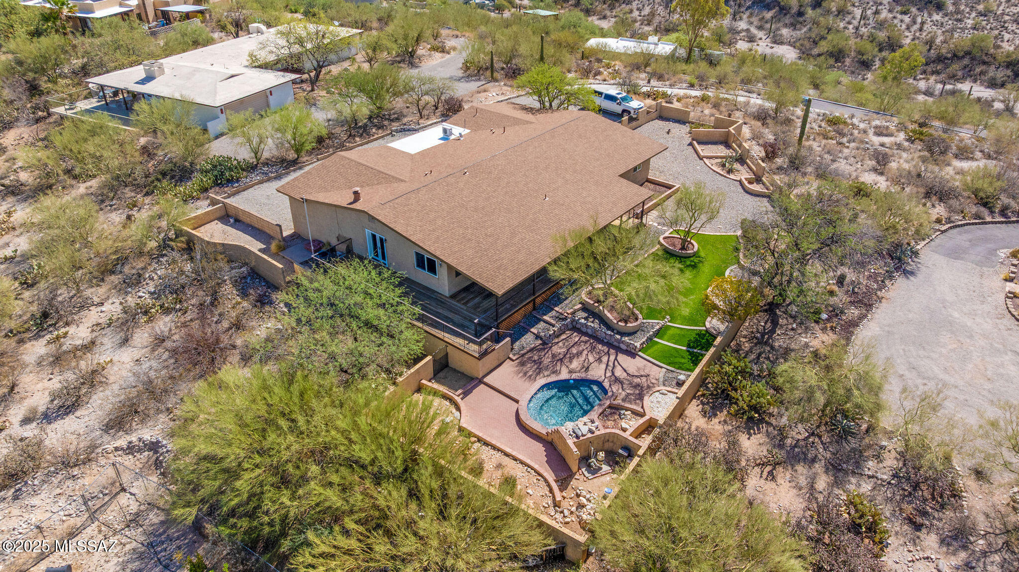 🌵 Luxury Living with Million-Dollar Views ⛰️-Without the Price Tag! Amazing opportunity for updated all electric 2,819 Sqft 3 bed+den/2.5 bath with refreshing pool, attached 594 Sqft finished 2 car garage+workshop, nestled on .86 acres CR-1 elevated lot perched high atop the prestigious La Buena Vida Estates of North Tucson's Catalina Foothills. This brillant modern ranch-style home offers unrivaled 360° panoramic mountain vistas and sparkling city lights—a rare blend of privacy, scenery, and sophisticated living. Step inside to discover luxury plank flooring and tile flooring throughout, recessed lighting, textured ceilings (no popcorn), and zoned dual HVAC systems (one new Rheem unit in 2019) with dual Nest smart thermostats for ultimate climate control. The updat open concept kitchen features full-slab granite countertops with bar seating, a butcher block island, sleek shaker-style cabinetry, a full suite of matching stainless-steel appliances, a walk-in pantry, and even a mini fridge-perfect for entertaining. The spacious family room, anchored by a dramatic stacked granite wood-burning fireplace, flows effortlessly into the open-concept layout with a formal dining area and views that command attention.
The massive primary suite is a serene retreat, complete with a deep walk-in closet with built-ins, and a remodeled en suite bathroom with executive-height granite dual vanities, a walk-in glass shower, and a separate soaking tub. Generously sized guest bedrooms and an updated full guest bath continue the high-end feel with matching finishes and designer touches.
Step outside to your private oasis: a sparkling pool with rock face waterfall, artificial grass area, expansive covered patio, wraparound deck, and masonry + view fencingall designed to soak in those iconic desert sunsets. Additional highlights include a long concrete driveway, exterior of home freshly painted May 2025, 2024 architectural shingle roof, 2025 additional gravel parking added, double gate backyard for toys, low $45 monthly HOA dues, dual water heaters, energy-efficient dual-pane windows, central vacuum, an internal laundry room, and a spacious 2-car garage with powered workshop.
Enjoy the space, views, and luxury of a multi-million-dollar propertywithout the price tag. Homes like this rarely come to market. Schedule your private tour today and experience Catalina Foothills living in Tucson, Arizona!!
