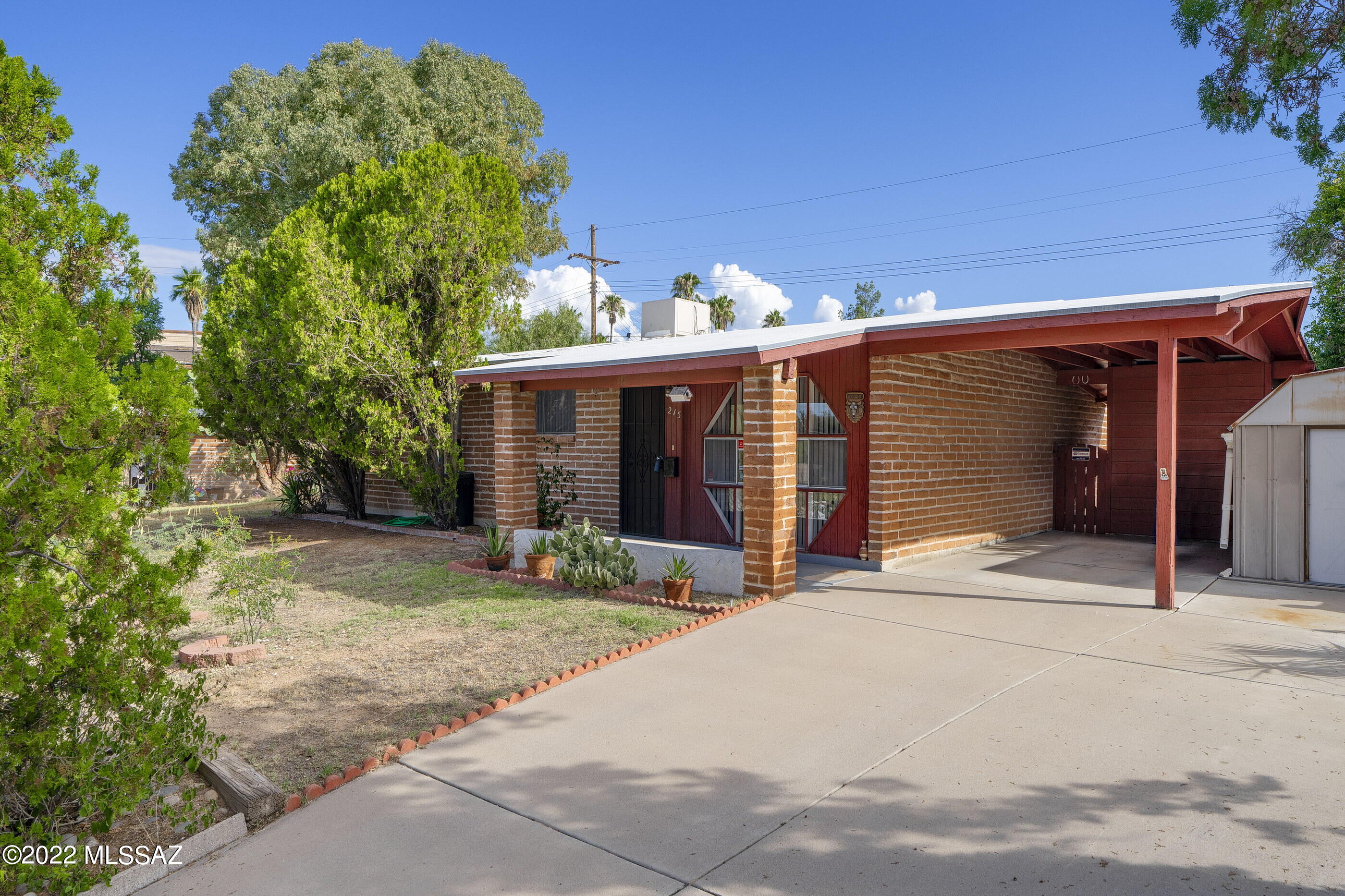 Why rent when you can own?  4 Bedroom 2 Bath  adobe home with separate living and family room.  Covered front porch,  extra long concrete driveway, carport and large lot.  RV parking space from the alley behind ( no existing gate).  Convenient to shopping, medical and bus.  Located just south of Broadway and east of Pantano.  Charming 1959 built home set off the main road on a cul-de-sac.  Capture rain water in the 800 gal cistern for the mature landscaping.  Ramada in the back yard and workshop and storage shed. No HOA.  Washer, dryer, refrigerator and water softener convey (as is).  Newer 2018 roof recoated 2022, furnace 2015.