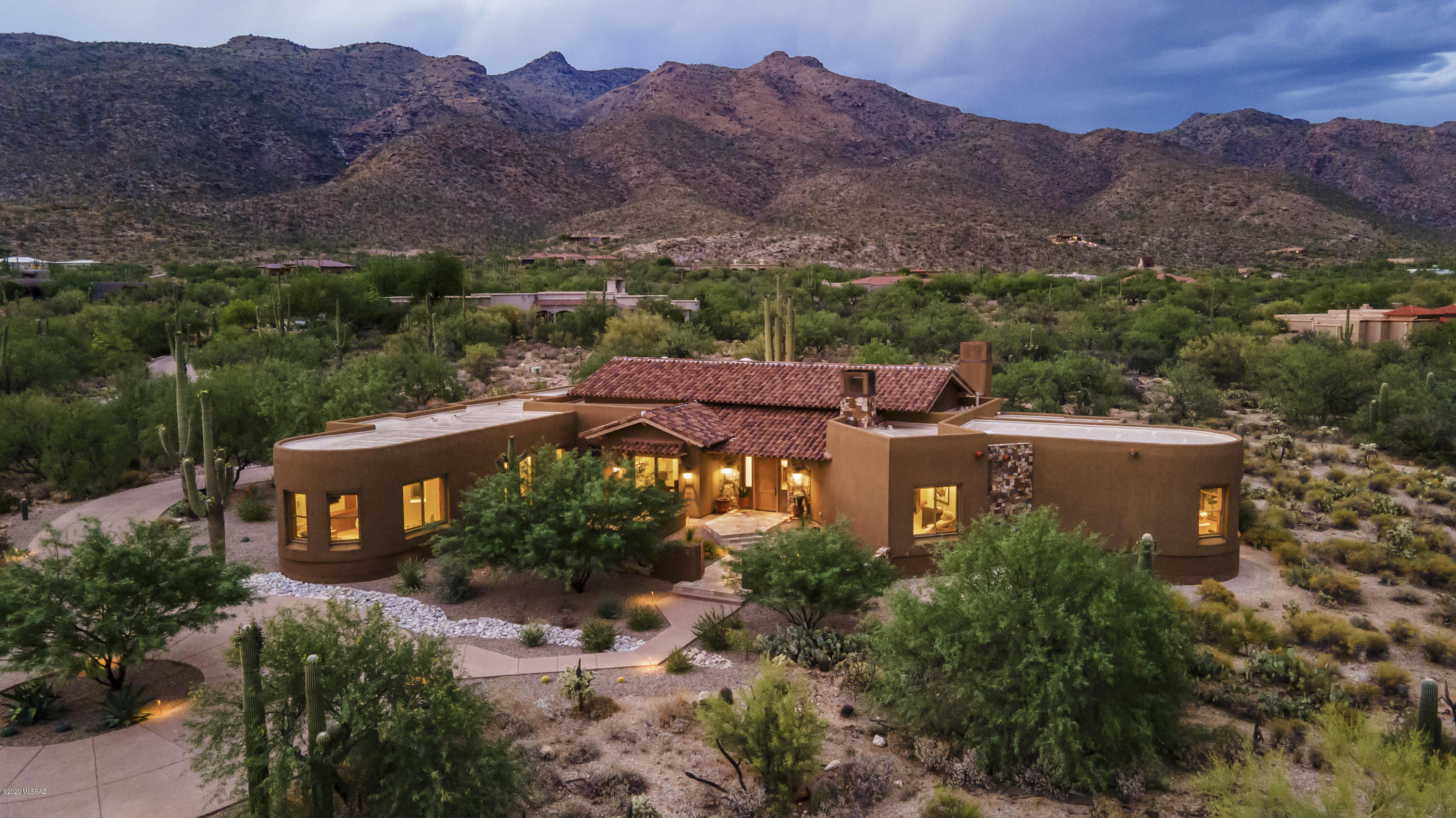 Recently built in NE Tucson's finest exclusive gated community-Saguaro Hills, by the award-winning team, Robinette Architects & Milestone Homes in 2017. Nestled in a quiet, private cul-de-sac, enjoy tranquil panoramic 
mtn/city views. Exquisitely appointed home, with timeless custom finishes inc a sliding wall of glass to expansive outdoor patio w/ fireplace & kitchen (fully retractable enclosure screens), custom wood windows, doors & trim pkg & pool/spa/fountain. Lg Guest House. Smart Home inc electric shades, Chef's Kitchen with Wolf/Sub Zero appl, Massive pantry & laundry rm, French patterned stone floors, open/split floor plan, Huge Master w/ Spa bath (steam  & outdoor shower & garden tub). Ultimate in Tucson living with amazing cycling, hiking & desert flora. See Feature Sheet