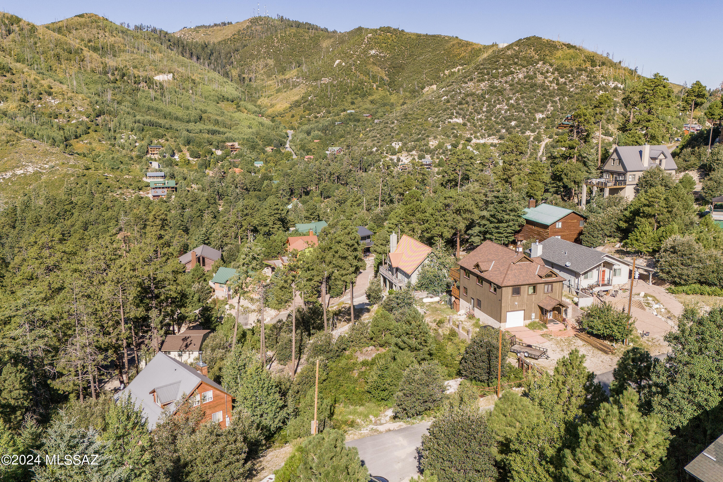 This special parcel of land, on Mt. Lemmon, is surrounded by mature trees and is located on a paved road, allowing for year-round access. It is situated in the heart of Summerhaven. Established homes nearby with water and electric at the road. The lot boasts views and is an ideal spot for your future cabin.