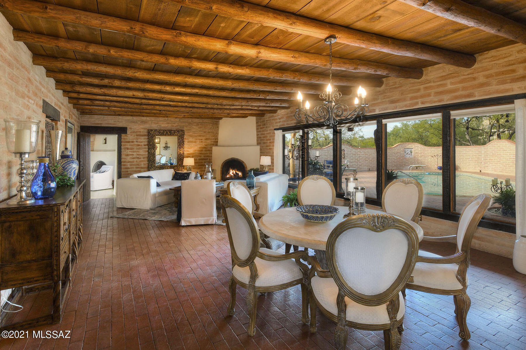 Truly charming classic Arizona burnt adobe territorial home sits on 2.2 acres w/ magnificent mountain views in the heart of the old Foothills. A lovely foyer entry w/custom mesquite double doors invites you into this exceptional home w/ 2,672 sqft. The spacious living area encompasses an exquisite great room w/ beam ceilings, elegant fireplace, walls of picture windows, brick floors, light & open kitchen w/ mesquite cabinets and mesquite countertops, refrigerator, pantry, 4 bedrooms including master w/ fireplace plus an executive study w/ built in bookcases, beautiful tile floors and custom wooden doors & shutters throughout. Enjoy the lovely backyard w/ covered brick patio, pool, spa, oversized 2 car garage w/ storage room, lush desert landscaping, Dist 16 schools majestic mountain view.