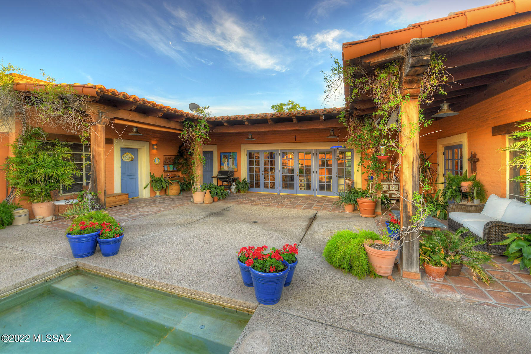 You know that feeling when you walk into a home and say to yourself '' I know I'm going to like these people''?  Yup, this is it. (and I do!) If the home you are searching for must be charming, must be classic, must be private, than you must see this.  Burnt adobe with the traditional U shaped Hacienda that depicts the best of Tucson.  Visualize a plethora of French doors anchoring the inner courtyard with pool. Even the guest house opens to this inviting space. I love the feel of Mexican Tile floors intimating a sense of history,White washed  beam ceilings, A master with a fireplace, and a guest house so large it could be 2 bedrooms and although 
 seperate, it is blended into the main house.  
 As an old Tucsonian, I so appreciate this find.

Pool and Spa Heater have never been used. Additionally, The master has 2 walk  in closets.  Guest house studio has a sink and a small office.
Dining Room Chandelier does not convey......  sentimental reasons.