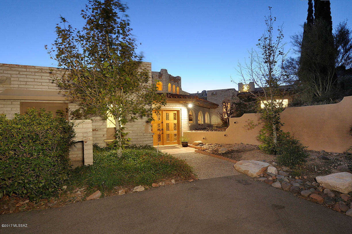This unique home located at the top of Skyline CC has absolutely stunning views of the city and beyond. The moment you enter this home, you will feel as though you are soaring over Tucson! This multi-level home has architectural character and designed with outstanding views from all rooms. This home was built for privacy. Retreat to your own master's quarters and enjoy private access to the pool as well as your own sauna and exercise room. The guest quarters include not only ensuite bathrooms and private access to the backyard but private living space and a bar as well. Enjoy the large fireplaces in the living room, master bedroom and office as you take in the views. Surreal views, covered patios and decks, a wine cellar, like new HVAC, water heaters, don't miss all this home has to offer!
