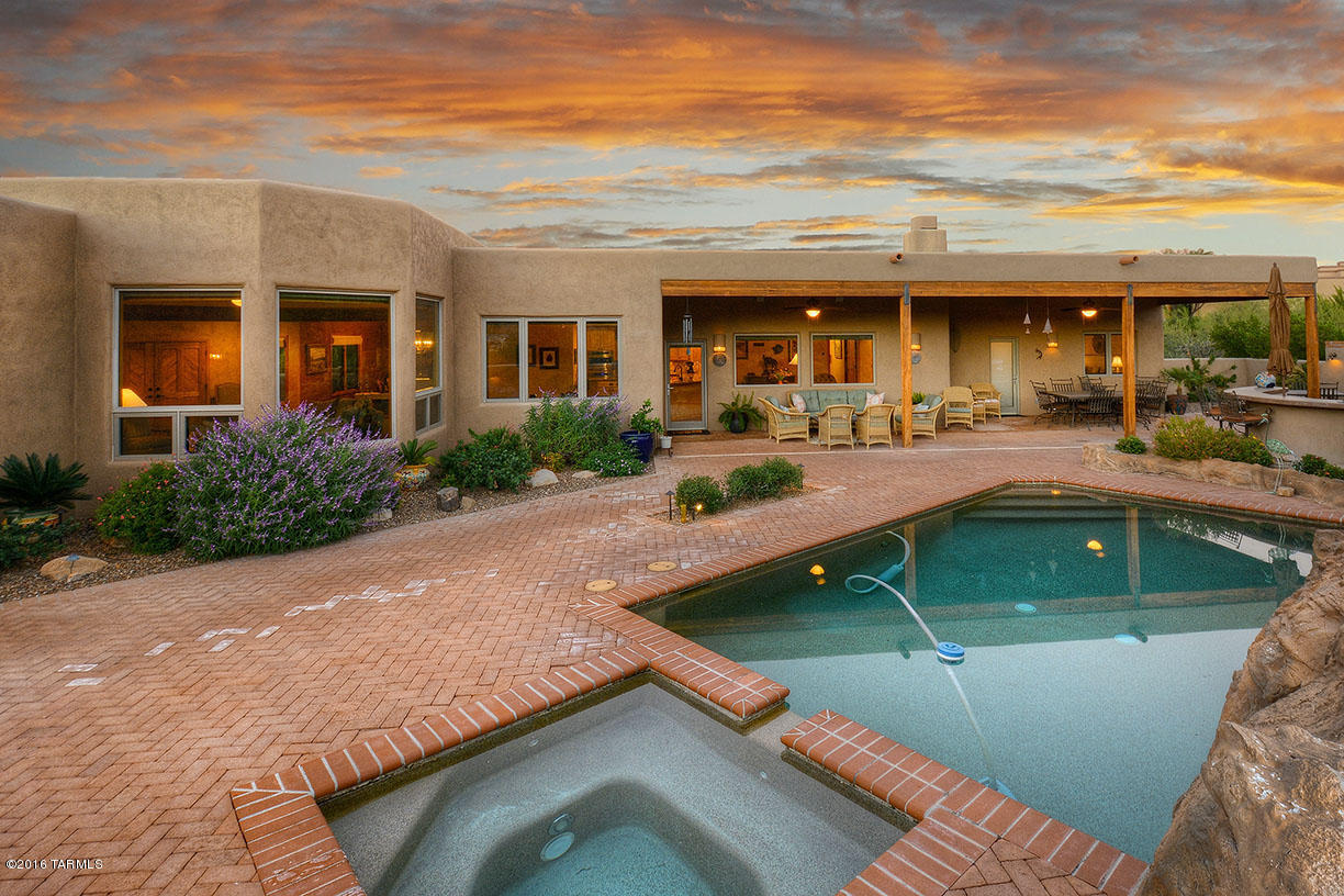 Beautiful southwestern custom home in pristine condition with stunning vistas. Enter thru the charming courtyard, into the living room with wood ceilings, tiled fireplace and windows framing the mountain views. Formal dining room with a door to enter a ''cooks dream kitchen'' with lots of counter space and cabinets, gas range, drawer dishwashers, warming drawer & walk-in pantry. Kitchen is open to family room with gas fireplace and built-in entertainment center. Luxurious master suite with sitting area, fireplace and 2 walk-in closets. This home also features 3 spacious bedrooms and a game room/exercise room or office. Huge backyard with complete privacy to enjoy the long covered patio, BBQ area with bar, kiva fireplace,  pool & spa.