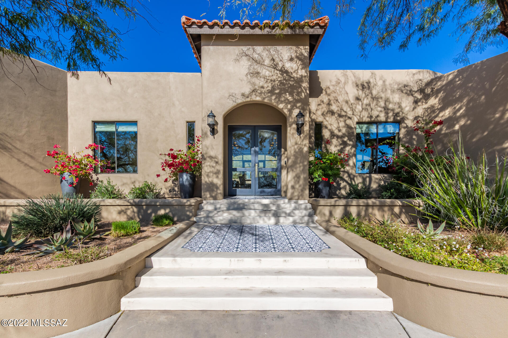 BREATHTAKING MOUNTAIN & CITY VIEWS! Spectacular residence nestled on a peaceful Catalina Foothills cul-de-sac. This property neighbors an 11+ acre nature preserve providing ultimate privacy! Discover an inviting living/dining area featuring high ceilings, handsome engineered wood flooring & striking light fixtures throughout. Aesthetically and architecturally pleasing! The stunning gourmet kitchen showcases white cabinetry, quartz countertops, high-end SS appliances, center island, and additional bar seating. Home features 2 master suites perfect for multi generational living. Absolutely gorgeous backyard featuring covered patio space with built-in BBQ, sparkling pool, premium turf & Ramada with a fireplace for those cool Tucson evenings. Not to mention the INCREDIBLE views all around!!