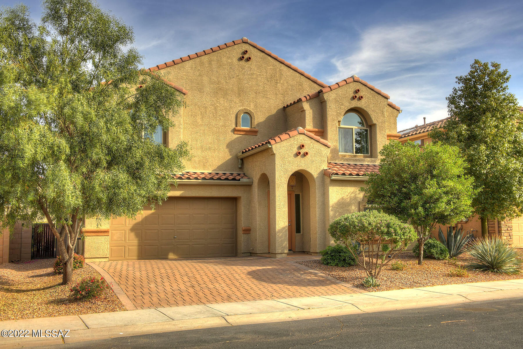 Welcome to beautiful Saguaro Bloom. 3-bed 2.5 bath 2015 built home. Cathedral ceilings soar above great room w/ clearstory windows. Banister of wrought iron & wood beckons to large 2nd story living spaces. Gourmet kitchen w/ island, water filter, stained maple cabinets & stainless appliances (brand new range) will make cooking & entertaining a joy. Fresh paint throughout, new bathroom vanity in 1/2 bath & new fixtures in upstairs bathrooms. Primary suite boasts huge walk-in closet, bathroom w/ rain shower, soaking tub & double vanity.  Covered back patio & landscaped backyard with stunning Tucson Mountain views. Paver Drive. Freshly coated concrete  2 car garage w/ space to store everything. Don't miss the gorgeous community pool, spa, workout room, park, walking trails & recreation center