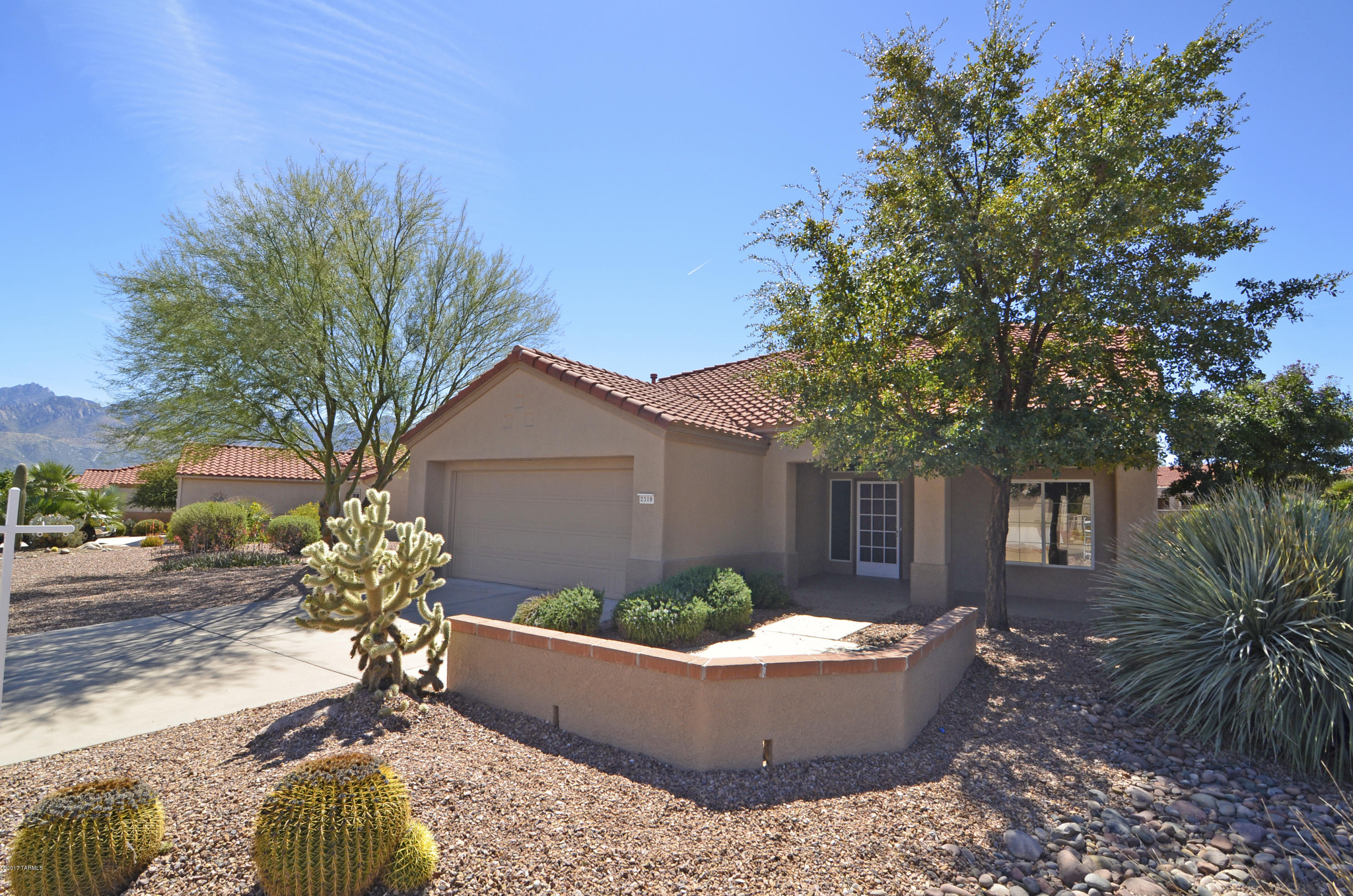 Beautiful Whitehall Model in Sun City Oro Valley. High Ceilings, an Open Floor Plan and Large Windows create a Light & Airy Ambiance. Bright Kitchen with Glass Top Range, Built-in Microwave & Breakfast Bar. Dining Area with Catalina Mountain Views Accommodates a Large Table for Entertaining. Open Family Room & Living Room. Spacious Master Suite with Walk-in Closet with Organizer. Private Adjoining Den or Sitting Room. Generous Master Bath with Soaking Tub, Separate Bath & Double Sink Vanity. Comfortable Guest Room with Built-in Murphy Bed & Desk. Full Guest Bath & Laundry Room. Fabulous Outdoor Living Space with Shady Covered Porch, Extended Patio, Meticulous Landscaping & Catalina Mountain Views. 2-Car Garage with Tons of Storage Cabinets & Utility Sink. Move-in Ready.