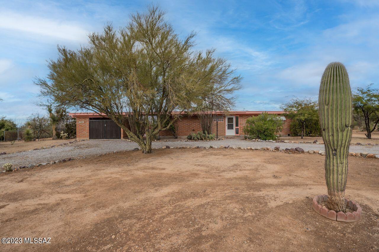 Your Private Oasis awaits! Situated on over an acre with fully fenced in backyard that backs up to a wash for extra privacy. Plenty of room for horses, RV, possibilities are endless.  Pebble Tec pool for those hot summer days and an above ground spa for relaxing in and checking out the star studded night sky. Closed in carport for all of your toys with plenty of storage. Beautiful Satillo Tile throughout this home. Come take a look before it's gone.