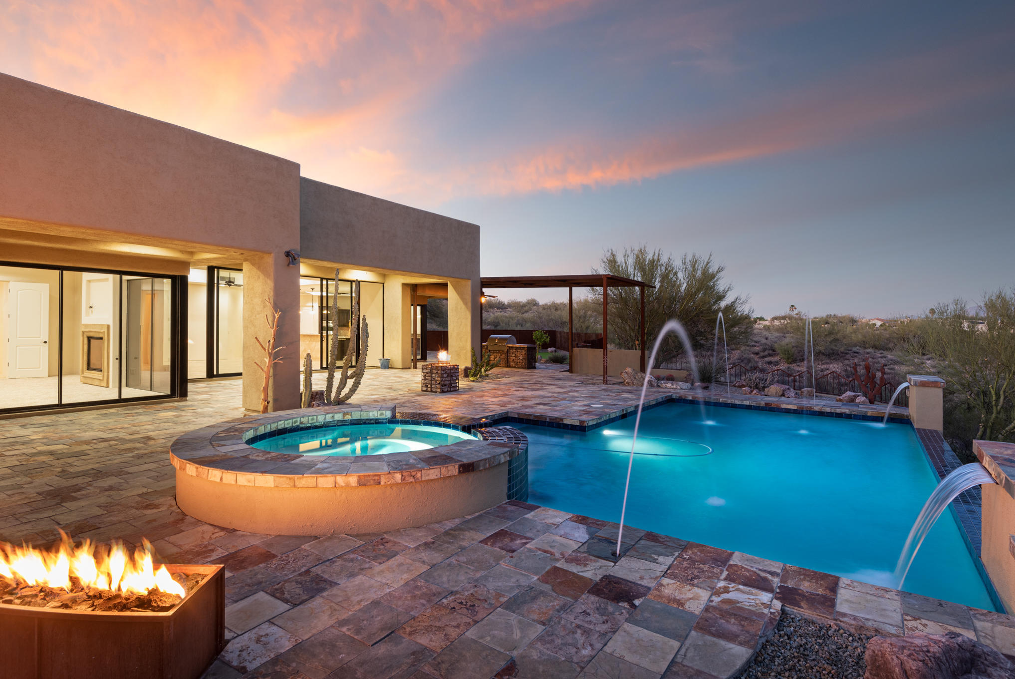 Breathtaking custom home. Built in 2007, this house is defined by elegant Mediterranean architecture, throughout its single-level design comprised of 3,642sqft. Superior craftsmanship displayed in intricate custom detailing marks the 5-bedroom, 4 bath structure, perfectly positioned to highlight the striking panoramic Pusch Ridge mountain views. Invite the outdoors inside through the glass door entry in the great room, along with the fireplace, accented with ''Canterra'' stone is complimented by floor to ceiling windows to maximize the Pusch Ridge view. The spacious master bedroom features private access doors which open onto its patio and view windows of the mountains. Exquisitely crafted walk-in closets, enclosing custom-designed built-in storage, view windows from master bedroom and bath provides beauty and convenience to the outdoor space. The master bath offers a custom tiles and a jetted jacuzzi tub. Guests will mingle as great meals begin in this chef's kitchen, equipped with rich, granite counter tops, two Prep Islands, Monogram stainless steel appliances,  pot filler, tumbled stone backsplash, and warm wood cabinets with pull-outs to enhance the adjacent dining area. The formal dining room adjoins the inviting living room, highlighted by a magnificent wood beams, and radius windows. The nicely oversized 3-car garage is constructed of copper patina garage doors, freshly painted concrete flooring and features plenty of useful storage. The backyard rests on the desert facing the Pusch Ridge Mountains, providing amazing sunset and sunrise views. A peaceful and serene setting inhabits the property's 1.25 acres, sparkling (pebble sheen) pool and elevated spa accented with (2 gas) rock fire pits, built-in BBQ and large covered patio with slate floor. This one-of-a-kind residence is located in a gated community on a cul-de-sac lot offering convenient access to schools, shopping, cultural center, golf, walking and biking trails.