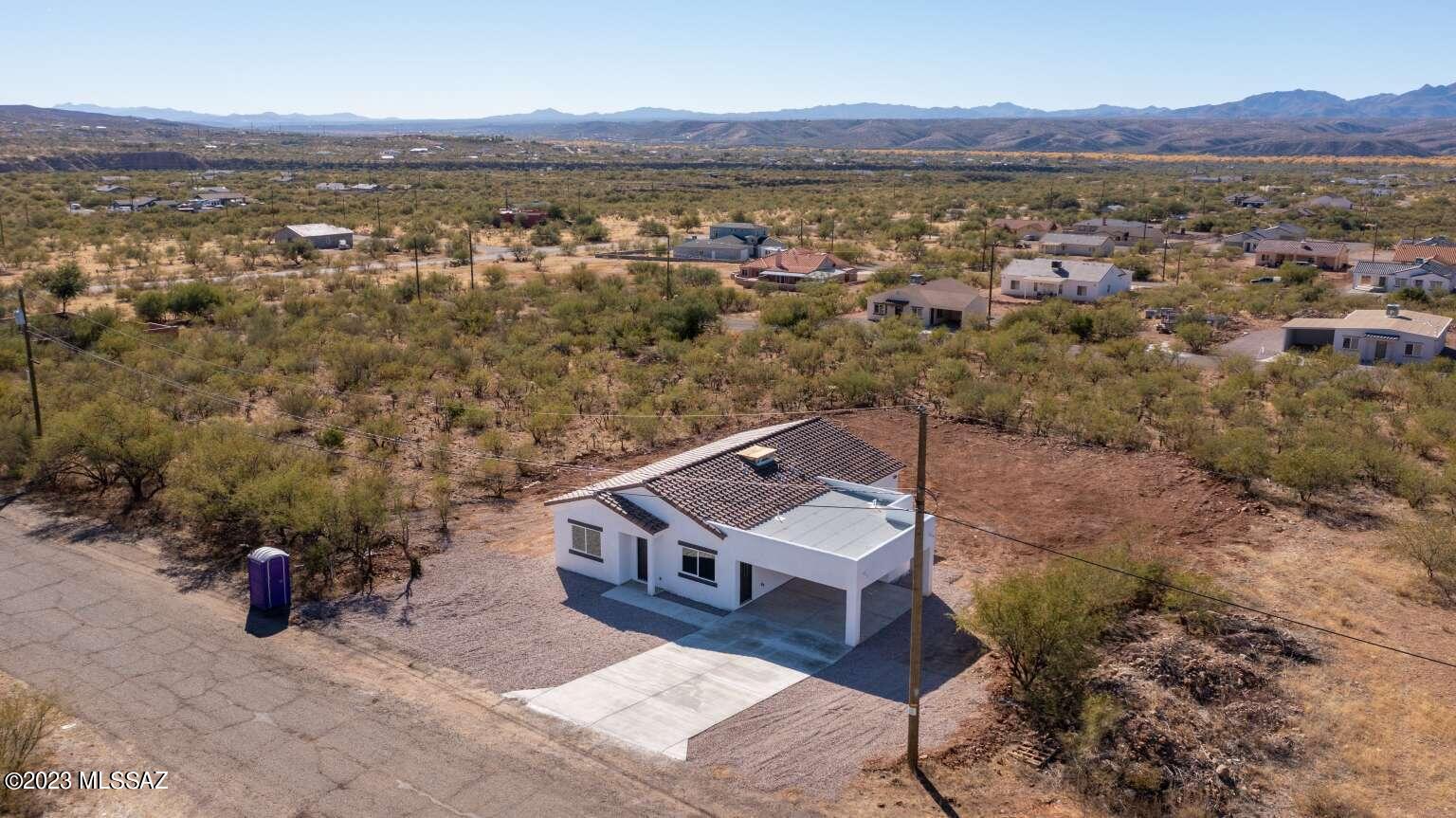 Welcome to your dream home in Rio Rico! This beautiful newly built home is perfect to start making memories. This modern home has 3 bedrooms and 2 bathrooms on a .30 acre lot. It is a open floor layout with high ceilings and recessed lighting throughout the home as well as ceiling fans in every bedroom including living room. The kitchen has custom cabinets, granite countertops, stainless steel electric appliances all included as well as a butchers block kitchen island. The home includes linen closets as well as a detached laundry room and 2 vehicle carport. The master bedroom has a walk in closet and master bathroom has a tile walk-in-shower. The backyard is a clean slate to use your imagination and creativity! Come see this beautiful home!