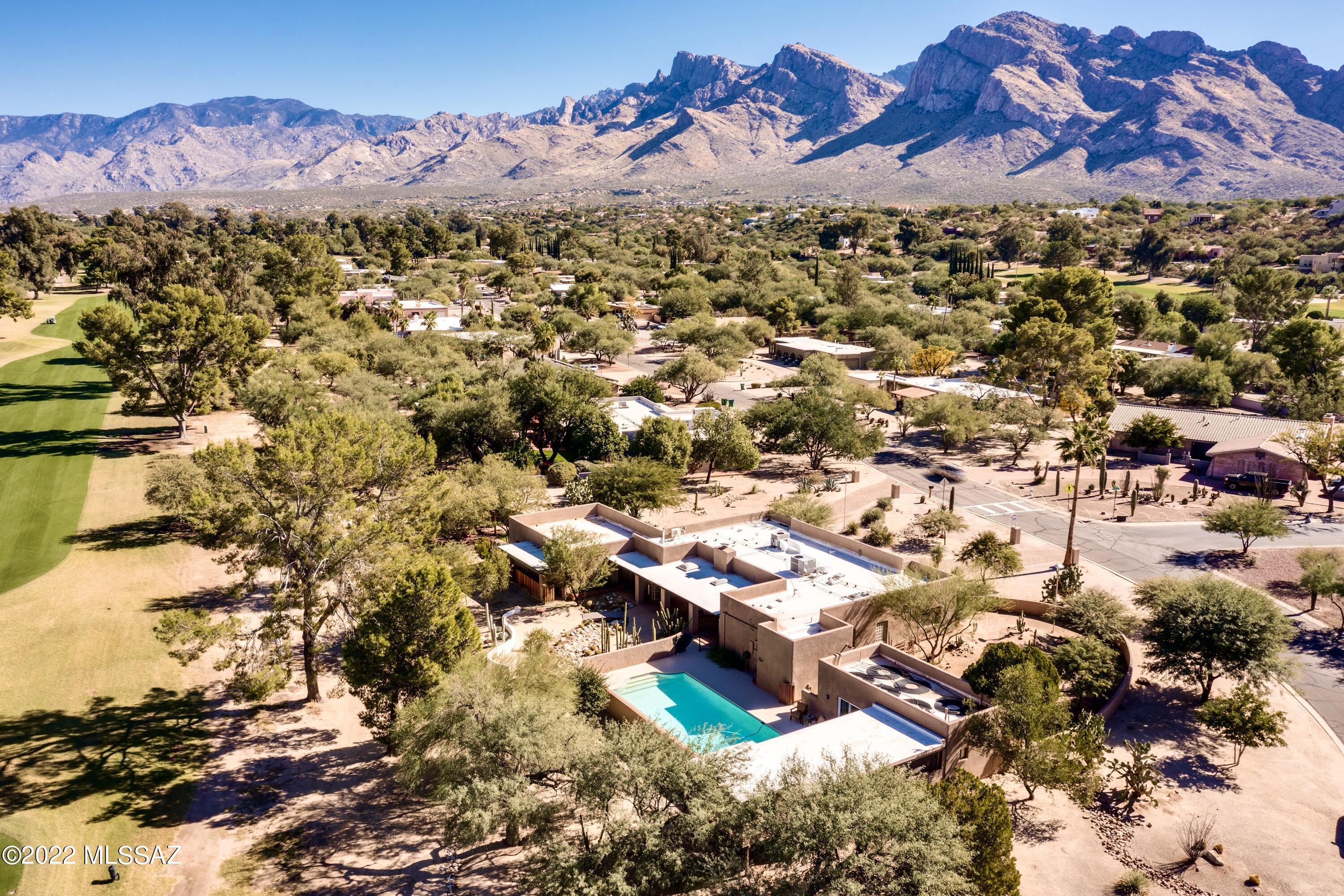 FABULOUS GOLF COURSE RETREAT ON THE 15TH FAIRWAY OF ORO VALLEY CC HAS IT ALL -- PARK-LIKE PROPERTY, TRANQUIL & FUNCTIONAL MAIN HOME PLUS GUEST CASITA! 1.1AC parcel offers MTN views from patio areas w/ramadas, solar-heated lap pool, gas fire features, covered patio w/skylights. MODERN HOME IS 2816sf, 4BR, 2.5BA. Great Room w/FP, sleek kitchen w/recent updates incl Bosch induction cooktop & flush mount vent hood, black SS appliances, recessed & pendant lighting, granite counters, pantry. Porcelain floor tile, Shoji Doors in living area & master BR. Complete Master bath remodel w/porcelain & glass tile, roll-in shower, dual vanities, new lighting & plumbing fixtures. ATTACHED 466sf GUEST CASITA has kitchenette, Murphy Bed, bath w/shower, sep entrance, private patio.Newer 2016 paver driveway.