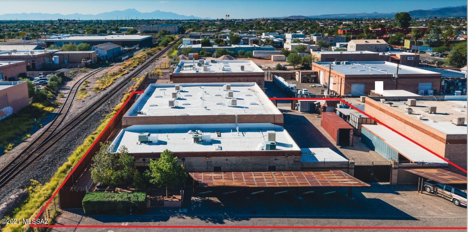 One of a kind Warehouse/Office currently used for high end design/manufacturing. Fully Secure compound constructed using masonry and steel. Office space is fully custom southwest design with mammoth hand hewn vega beams & tongue/groove ceilings, thick adobe/plaster walls, and brick paver flooring. Warehouse has 20' ceilings with 480VAC, 400A electrical service with multiple drops for 480V, 208V 3ph and 240V, 120V single Phase. Compressed Airlines and regulators at multiple locations. 3 AC Units for Office, Warehouse is evaporative cooled.Mezzanine storage area. 350sf outbuilding with insulation and multiple covered outdoor work/storage areas. Great location close to downtown &  I-10