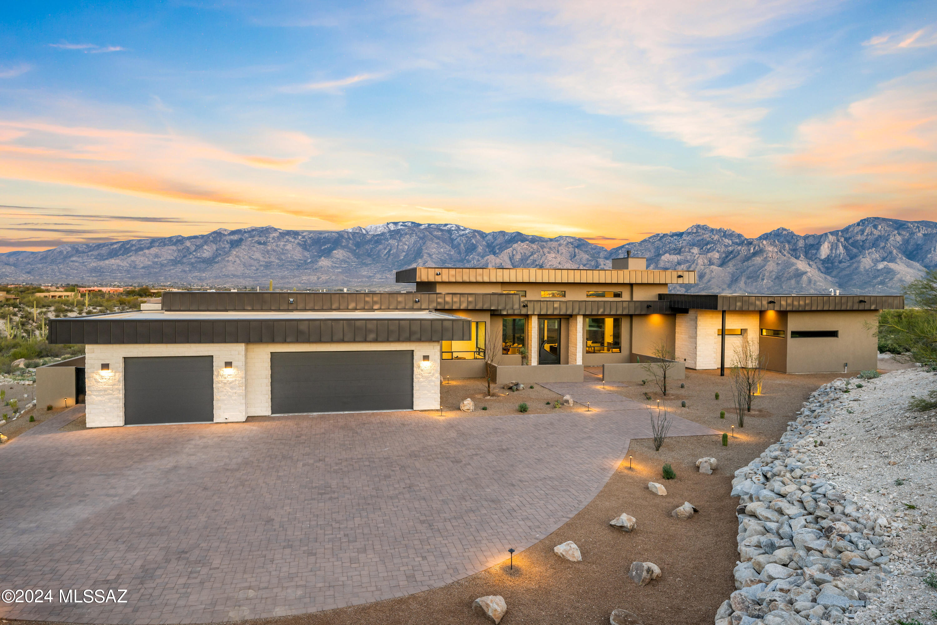 Welcome to a lavish retreat nestled within the prestigious confines of The Stone Canyon Club. This awe-inspiring residence epitomizes luxury living with its impeccable blend of contemporary elegance and natural charm.
Step inside this architectural masterpiece and be greeted by the seamless fusion of form and function. With 3 bedrooms and 4 baths, each corner of this residence exudes sophistication and comfort. Experience the epitome of culinary excellence in the gourmet kitchen, adorned with top-of-the-line Wolf and Subzero appliances, complemented by sleek Dekton countertops.
As you wander through the open floor plan, walls of glass invite the stunning beauty of the Catalina Mountains indoors, providing a breathtaking backdrop to every moment. Revel in the tranquility of the expansive living spaces, adorned with tile flooring that adds a touch of refinement to the ambiance.

Retreat to the sanctuary of the bedrooms, where relaxation knows no bounds. Each bedroom boasts its own en-suite bathroom, offering privacy and opulence at every turn. The guest wing further indulges visitors with a beverage bar, ensuring hospitality reigns supreme.

Convenience meets luxury with a large laundry room and a 3-car garage, providing ample space for storage and organization. Outside, over an acre of land beckons, offering endless possibilities for outdoor entertainment and relaxation.

This residence is more than just a home; it's a testament to organic modern architecture, boasting soft earthy tones that harmonize effortlessly with the natural surroundings. Located in the exclusive of The Stone Canyon Club, residents enjoy access to world-class amenities and the unparalleled beauty of the desert landscape.

Escape to a world of refinement and tranquility, where every detail has been meticulously crafted to exceed the highest expectations.